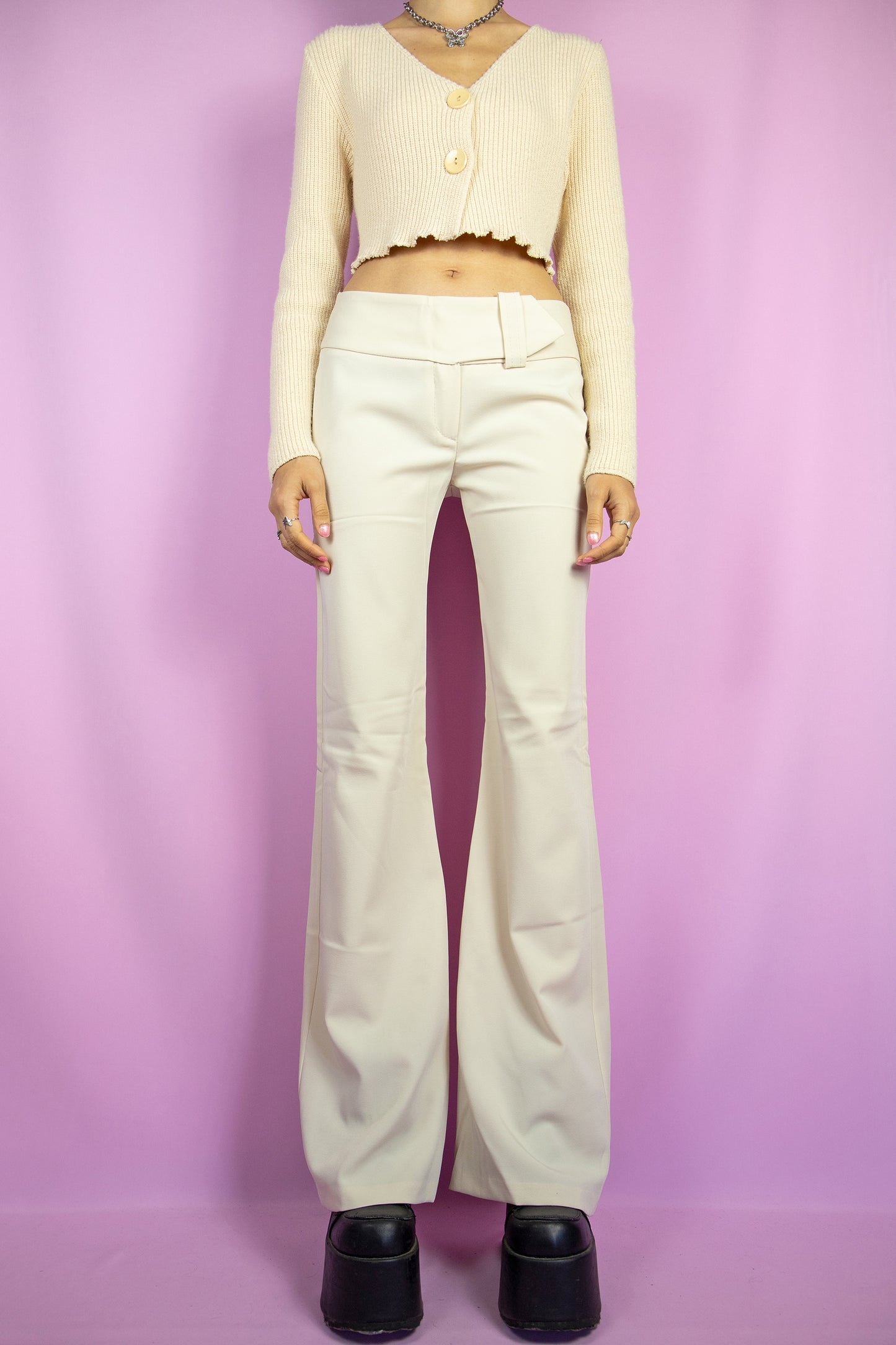 The Y2K Beige Mid Rise Flare Pants are vintage 2000s slightly stretchy wide trousers with a belt detail. Made in Italy.