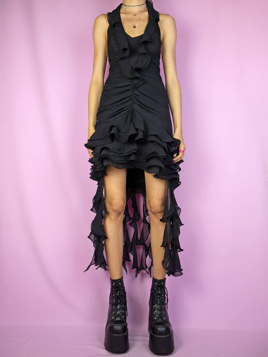 The Vintage 90s Black Asymmetric Ruffle Dress is a black sleeveless halter neck mini dress with ruched front, ruffle details and back zipper closure. Cyber goth party night 1990s avant garde midi dress.