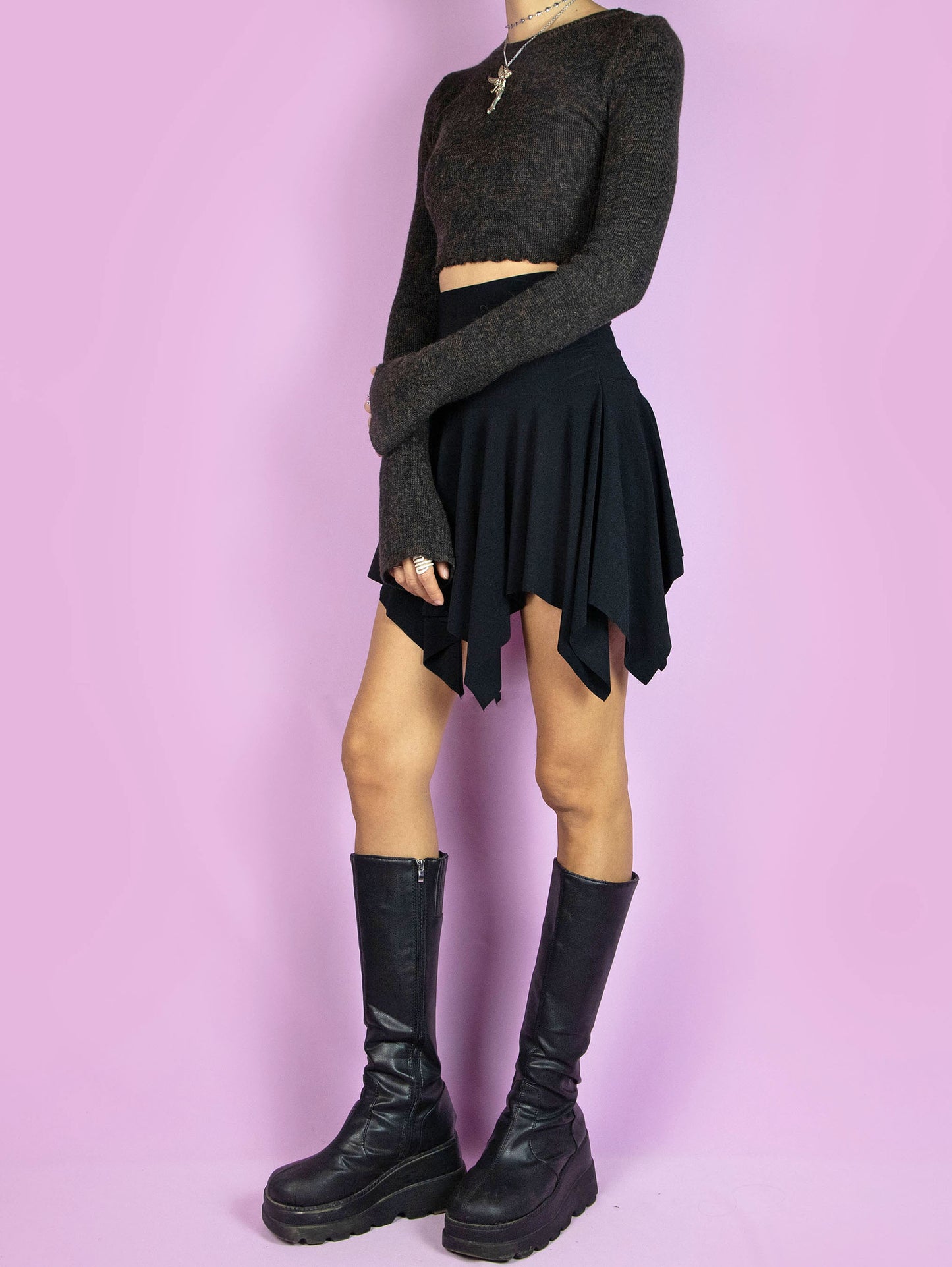 The Y2K Black Handkerchief Mini Skirt is a vintage black skirt with an asymmetrical pointed hem and elastic waistband. Fairy grunge goth 2000s party mini skirt.