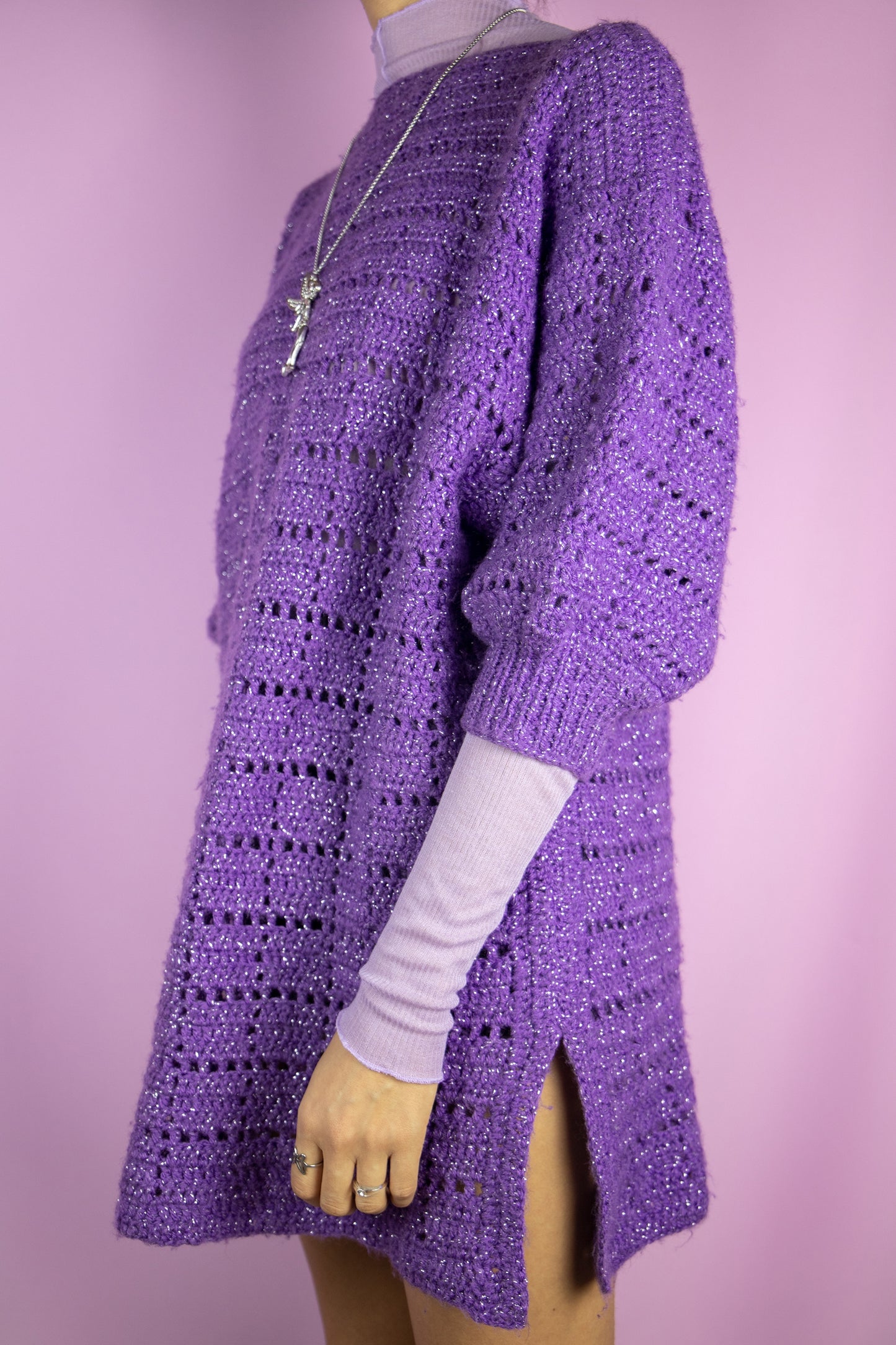The Vintage 90s Purple Crochet Knit Sweater is a purple chunky knit short sleeve pullover with silver threads details. Lovely boho party 1990s statement sweater.