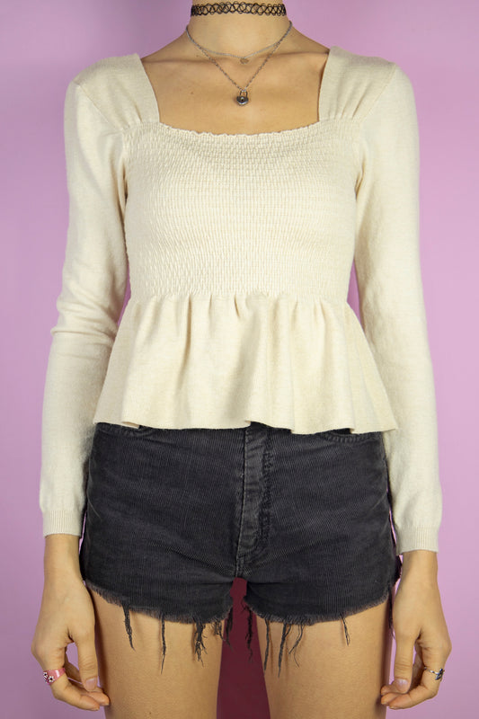 The Y2K Beige Shirred Top is a vintage ruched long sleeve knitted top. Fairy cottage 2000s sweater.