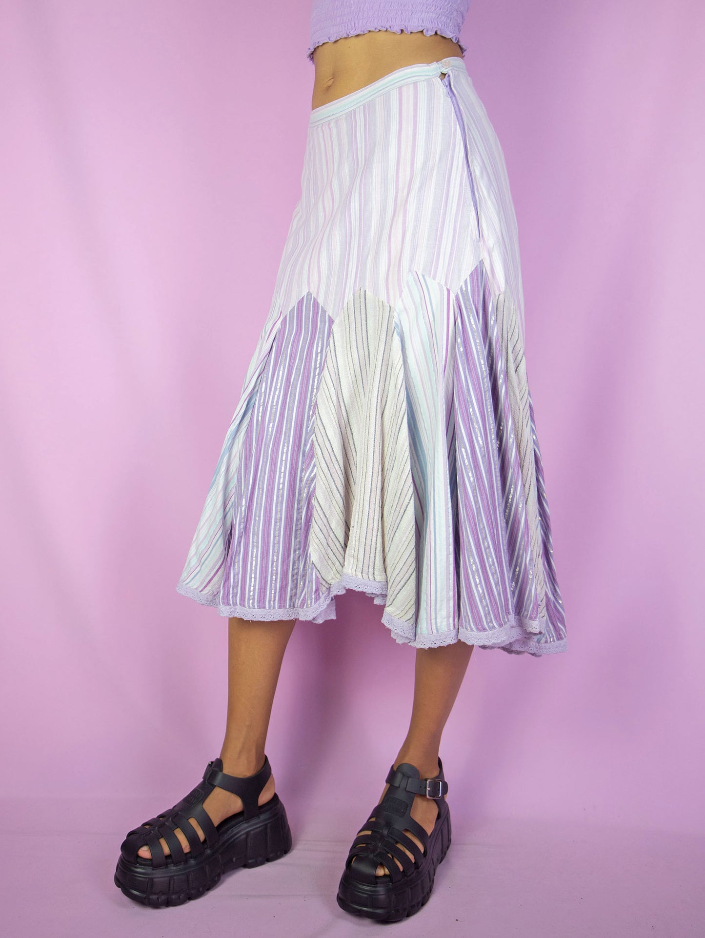 The Y2K Godet Trumpet Midi Skirt is a vintage 2000s romantic fairy inspired pastel purple lilac multicolored striped print skirt with side zipper closure.