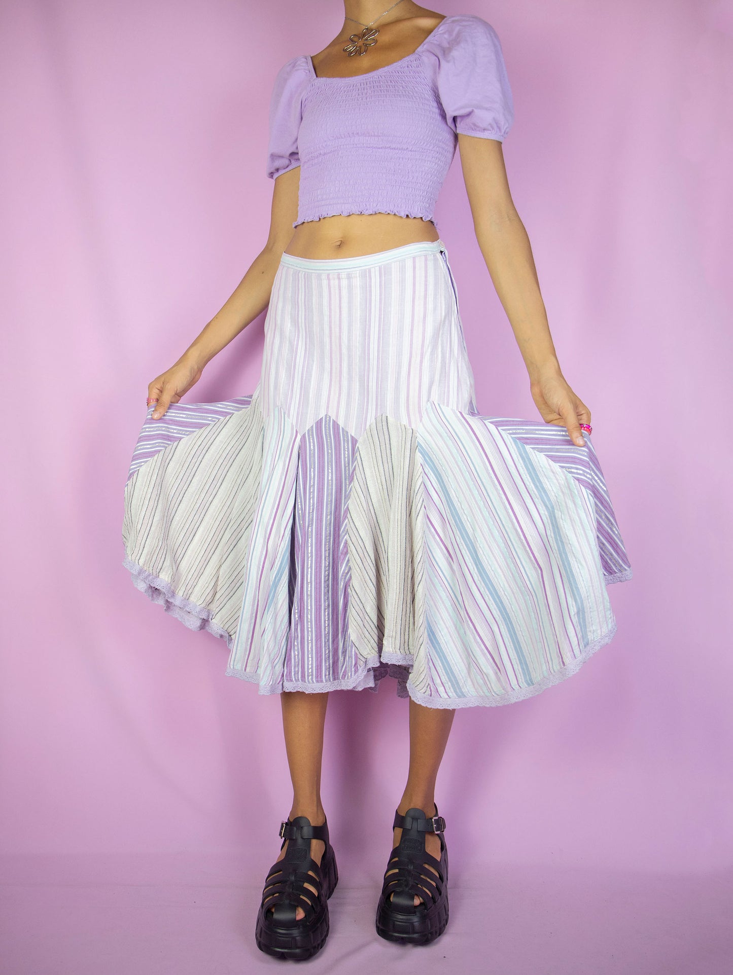 The Y2K Godet Trumpet Midi Skirt is a vintage 2000s romantic fairy inspired pastel purple lilac multicolored striped print skirt with side zipper closure.