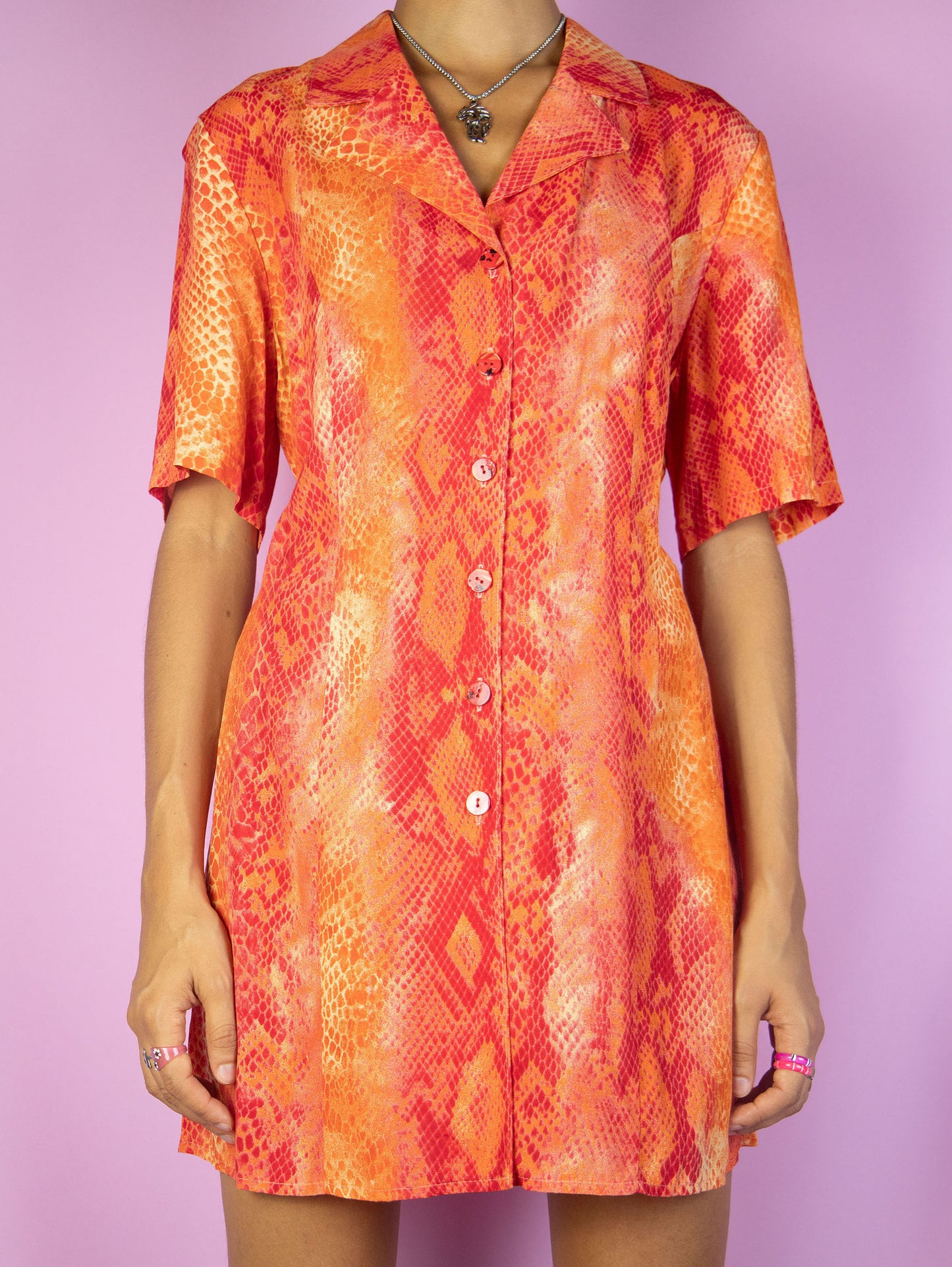 The Vintage 90s Red Snake Print Blouse is a short sleeve red and orange snake animal print top with a collar and buttons. Cyber summer festival 1990s party shirt.