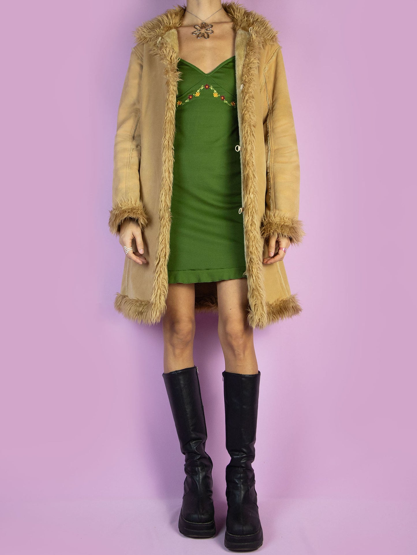 The Y2K Penny Lane Beige Coat is a vintage light brown beige faux suede coat with faux fur interior, collar, and cuffs. It also has pockets and a hook closure. Boho fairy grunge 2000s afghan-inspired winter statement jacket.
