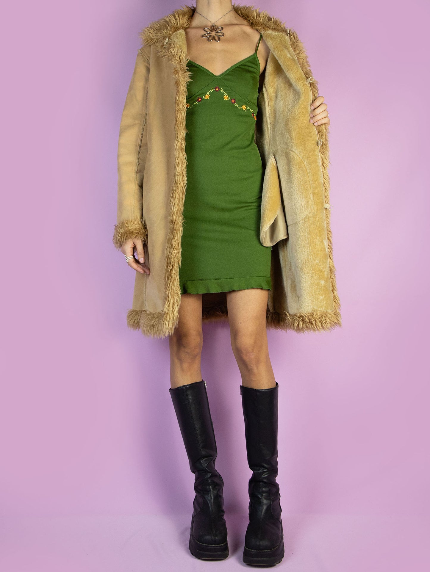 The Y2K Penny Lane Beige Coat is a vintage light brown beige faux suede coat with faux fur interior, collar, and cuffs. It also has pockets and a hook closure. Boho fairy grunge 2000s afghan-inspired winter statement jacket.