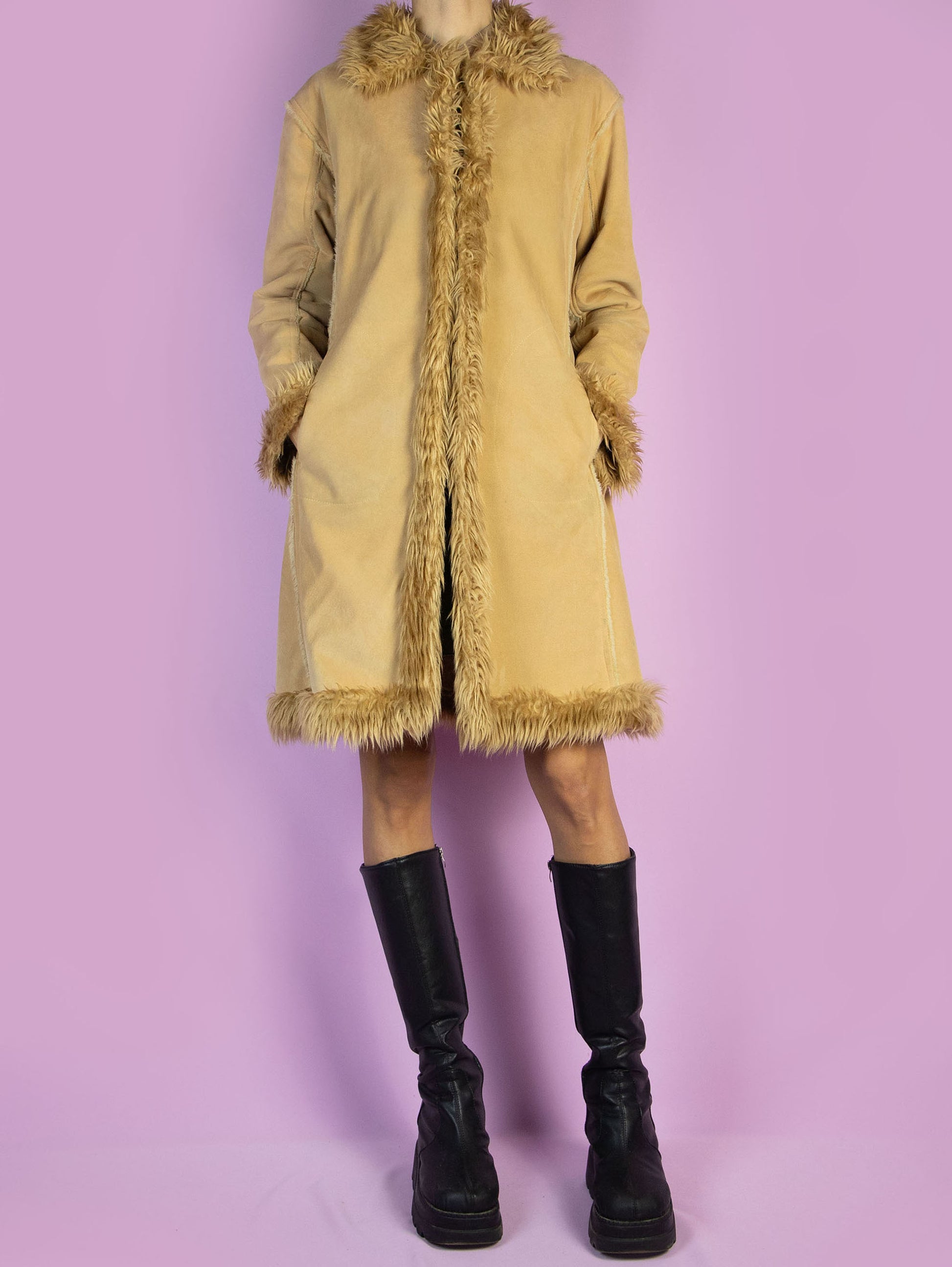 The Y2K Penny Lane Beige Coat is a vintage light brown beige faux suede coat with faux fur interior, collar, and cuffs. It also has pockets and a hook closure. Boho fairy grunge 2000s afghan-inspired winter statement jacket.