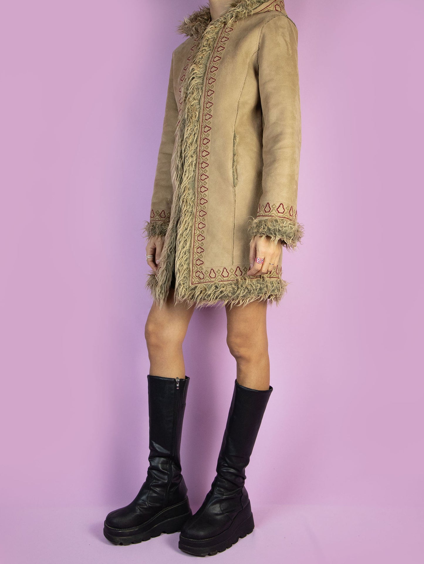The Y2K Beige Hooded Afghan Coat is a vintage light brown beige faux suede coat with faux fur interior, collar, and cuffs. It also features a hood, pockets, and hook closure. Boho fairy grunge whimsygoth 2000s penny lane winter statement jacket.