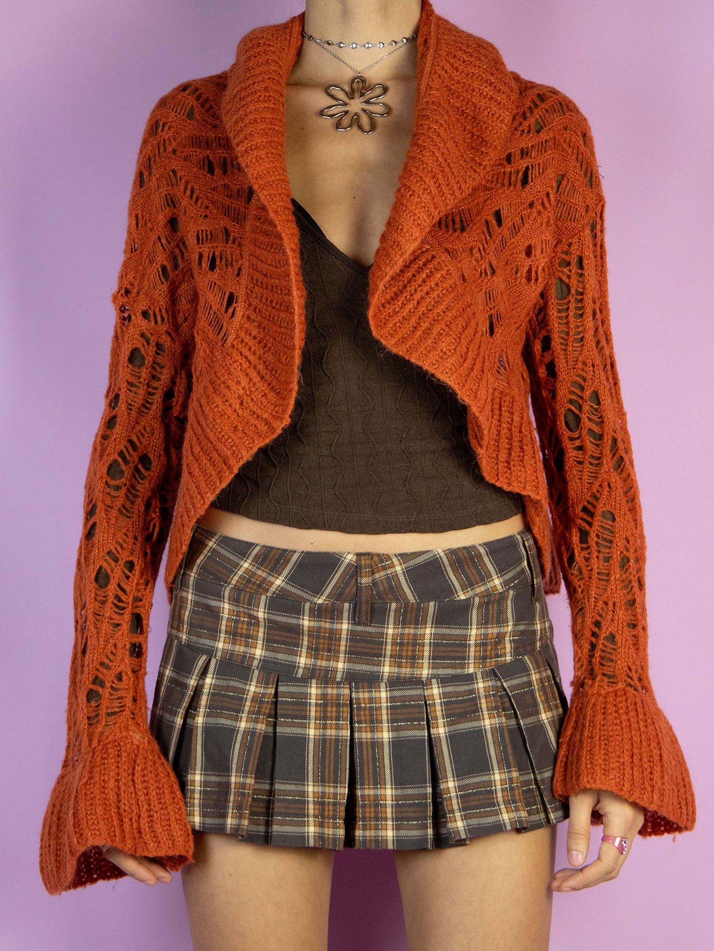 The Y2K Orange Knit Bolero Shrug is a vintage open orange cardigan with bell sleeves. Boho fairy grunge 2000s crochet knit bolero jacket.
