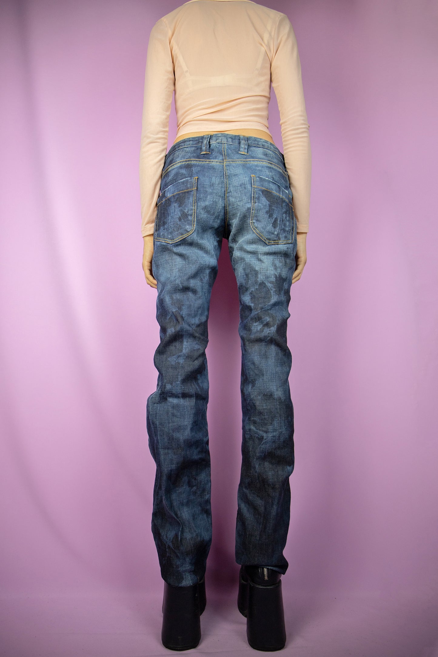The Y2K Low Rise Bleach Jeans are vintage tie-dye bleached straight pants with pockets, a raw hem, and a subtle stretch. Cyber grunge 2000s dark denim pants.