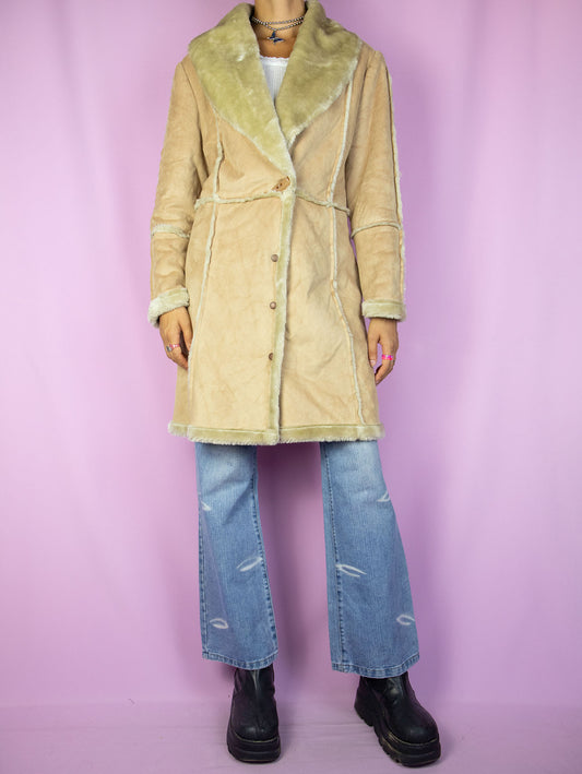 The Y2K Faux Suede Beige Coat is a vintage 2000s winter faux suede statement coat with faux fur lining, v-neck, and snap-button closure.
