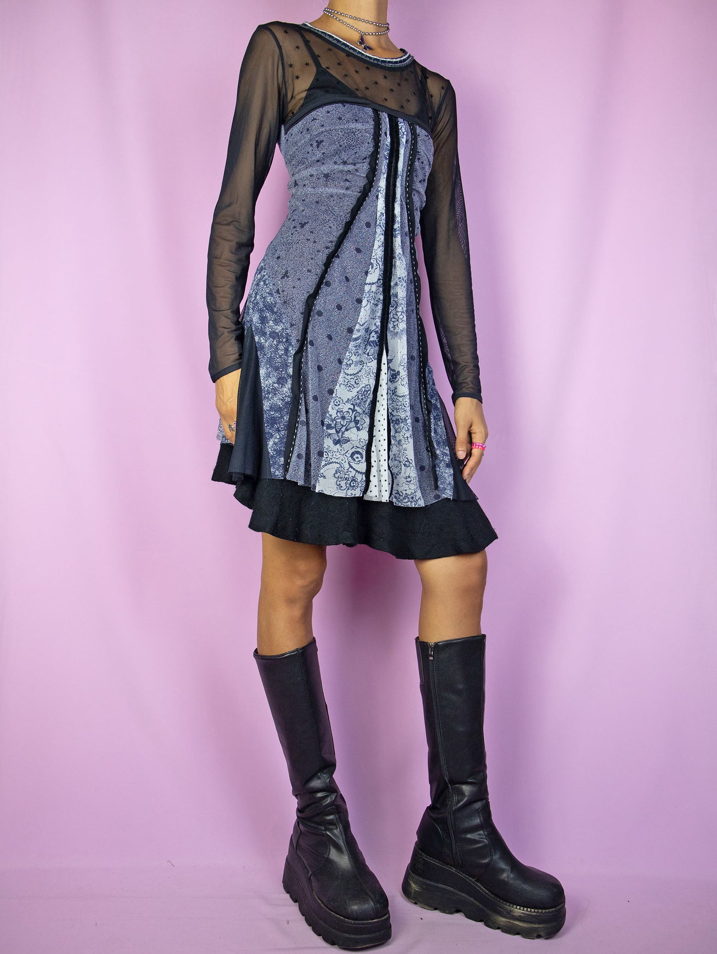 The Y2K Dark Fairy Mesh Mini Dress is a vintage long-sleeve flared dress in black, navy, and white semi-sheer mesh with an abstract print and ruched details. A cute avant-garde fairy grunge gothic subversive dress from the 2000s.