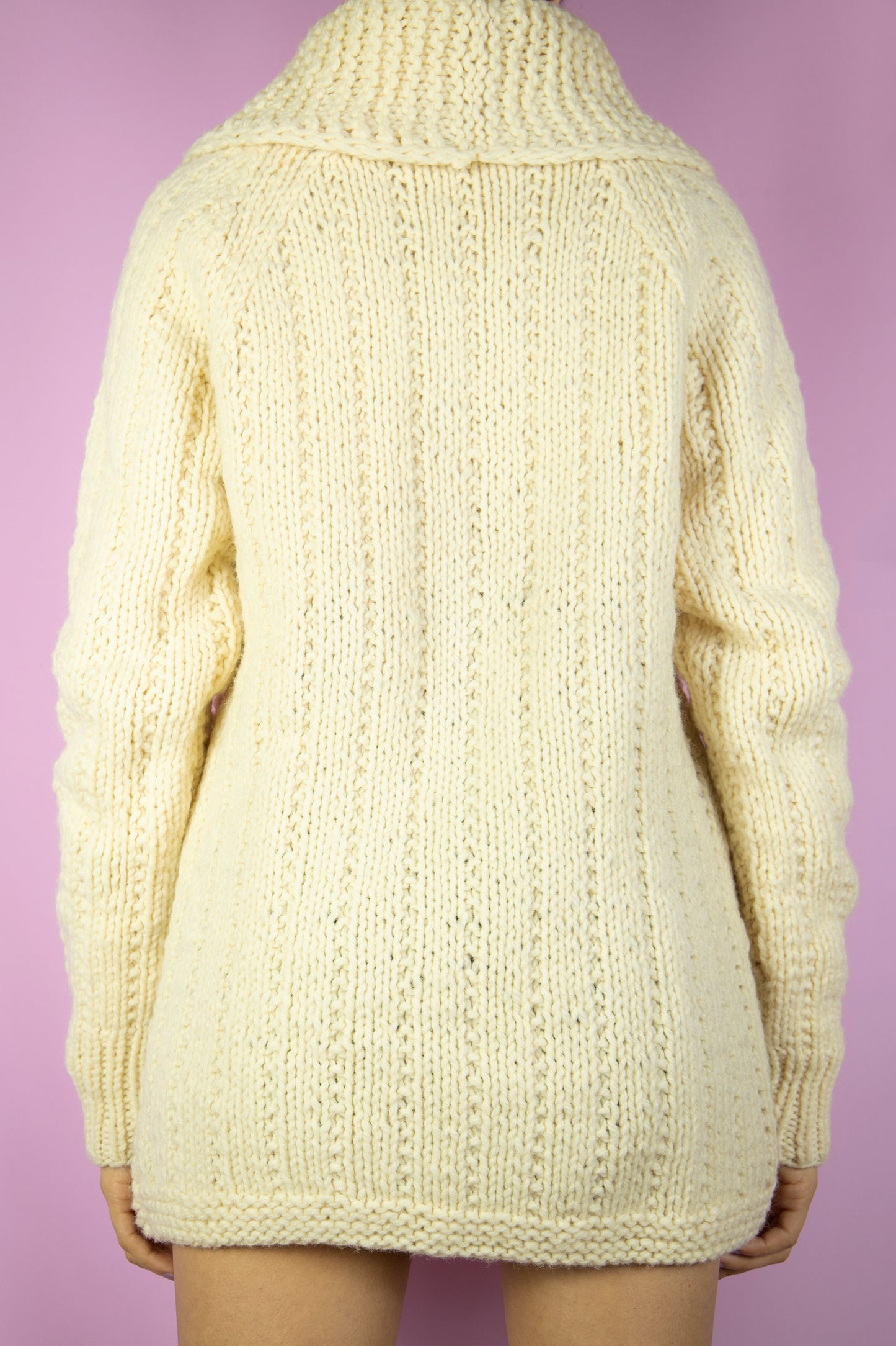 The Vintage 90s Beige Wool Knit Cardigan is a cream chunky hand knit wool cardigan with buttons and pockets. Boho retro 1990s winter sweater.