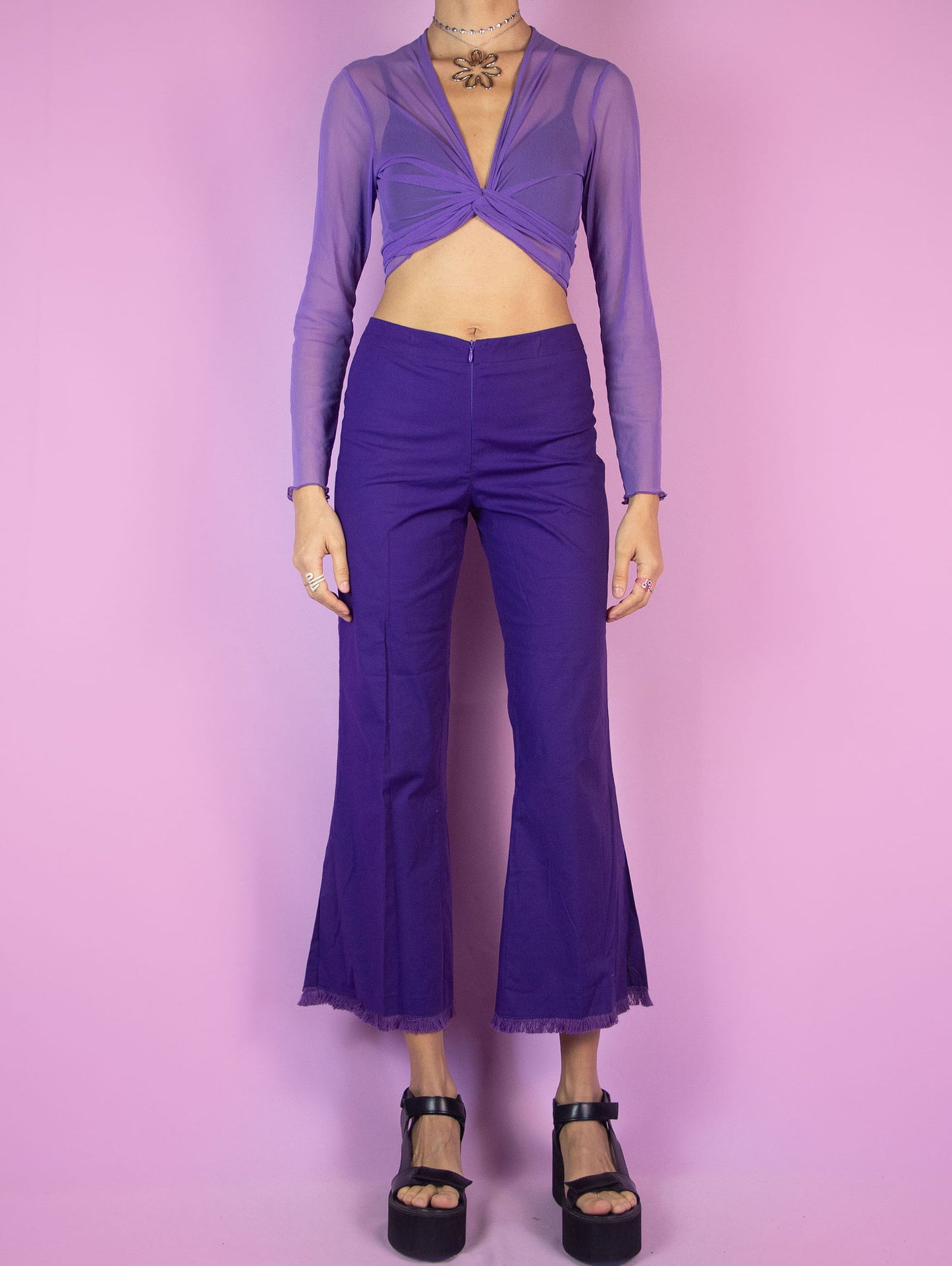 The Y2K Purple Cropped Capri Pants are vintage dark purple slightly elastic pants with a front zipper closure, featuring slits at the hem and frayed fringe. Cyber 2000s boho summer trousers.