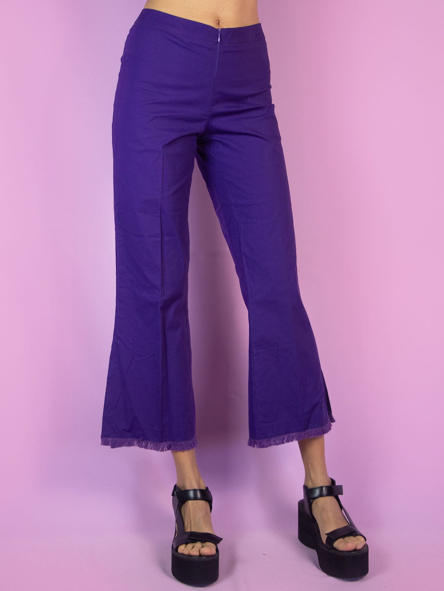 The Y2K Purple Cropped Capri Pants are vintage dark purple slightly elastic pants with a front zipper closure, featuring slits at the hem and frayed fringe. Cyber 2000s boho summer trousers.