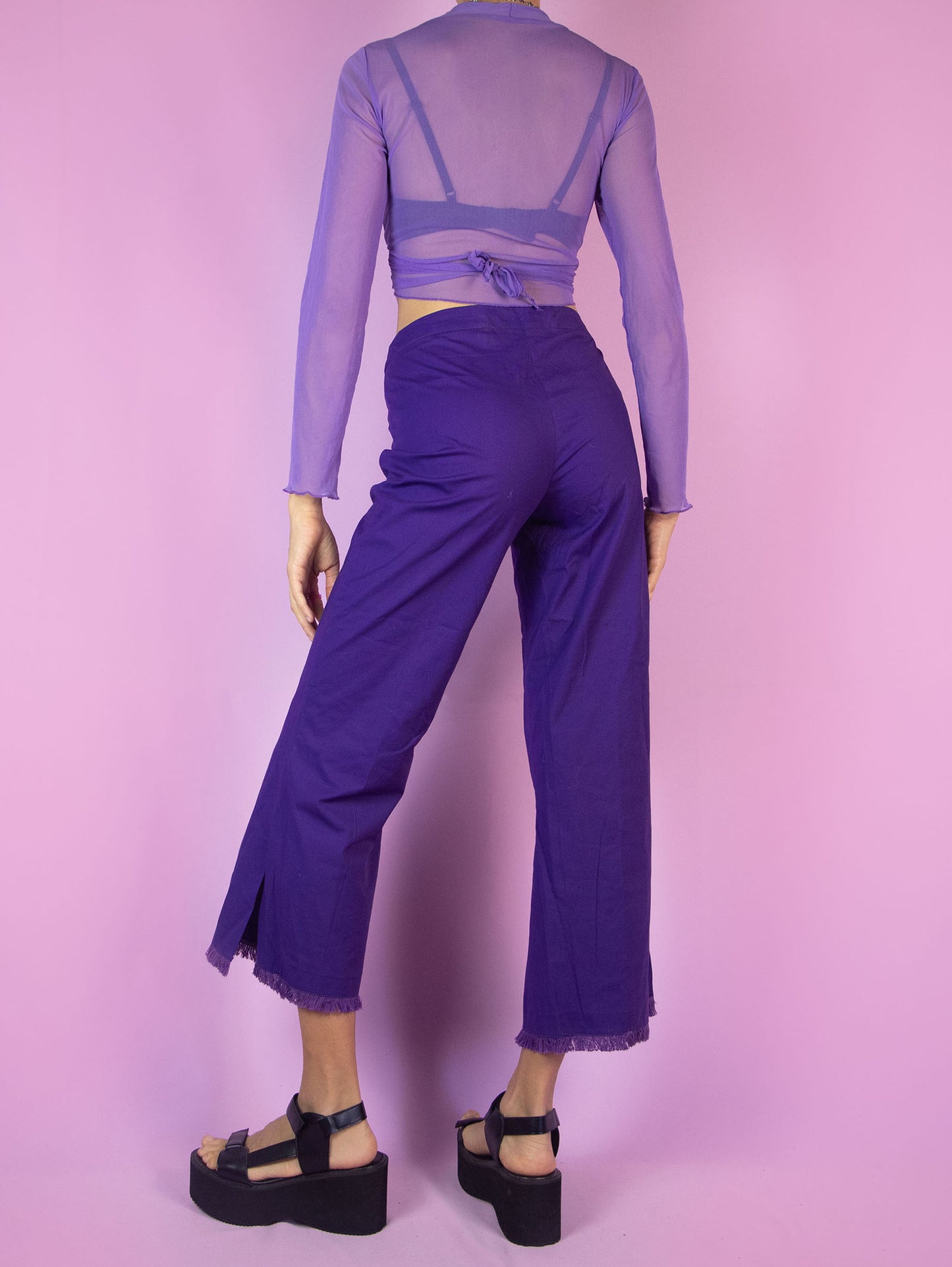 The Y2K Purple Cropped Capri Pants are vintage dark purple slightly elastic pants with a front zipper closure, featuring slits at the hem and frayed fringe. Cyber 2000s boho summer trousers.