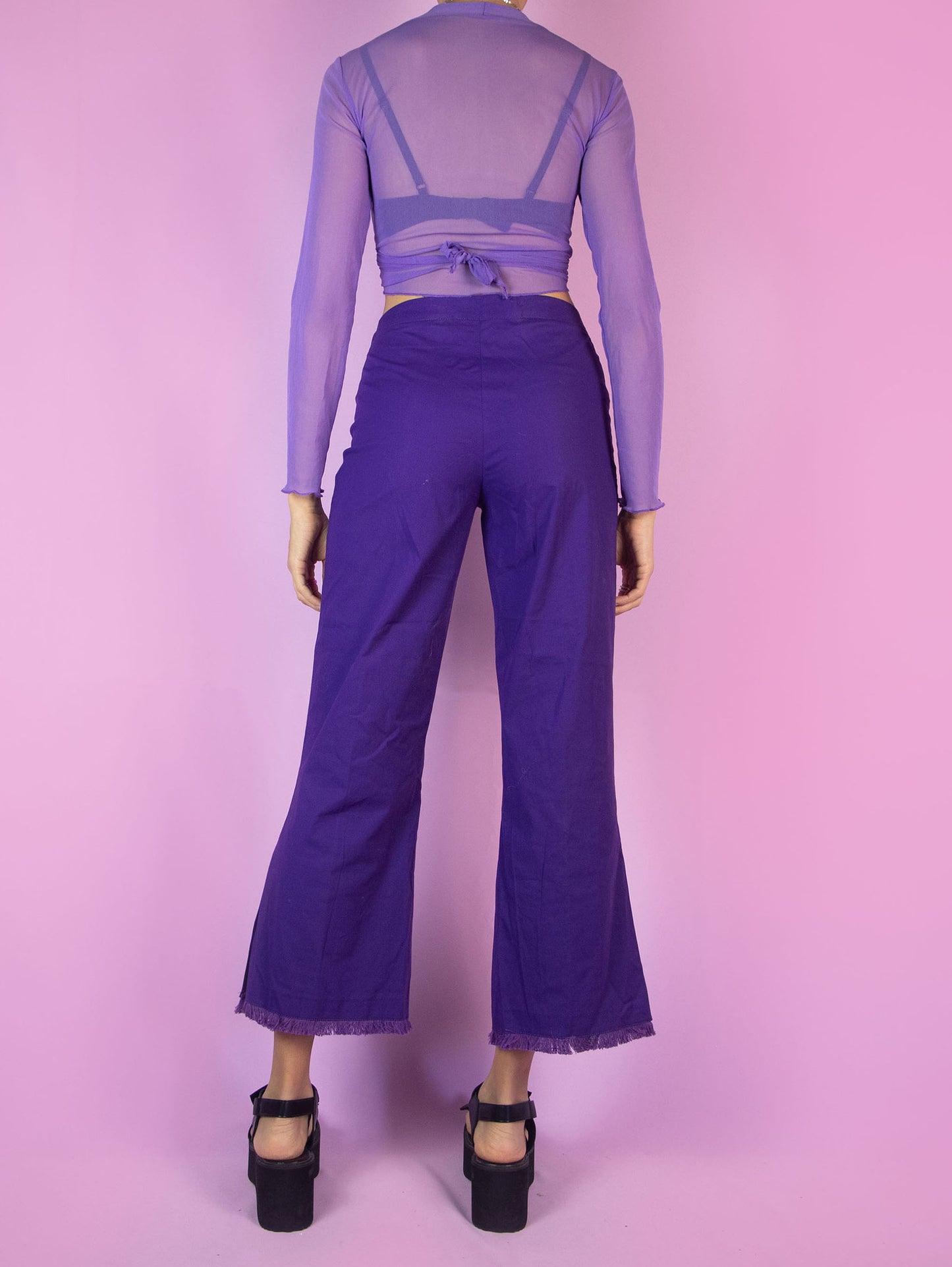 The Y2K Purple Cropped Capri Pants are vintage dark purple slightly elastic pants with a front zipper closure, featuring slits at the hem and frayed fringe. Cyber 2000s boho summer trousers.