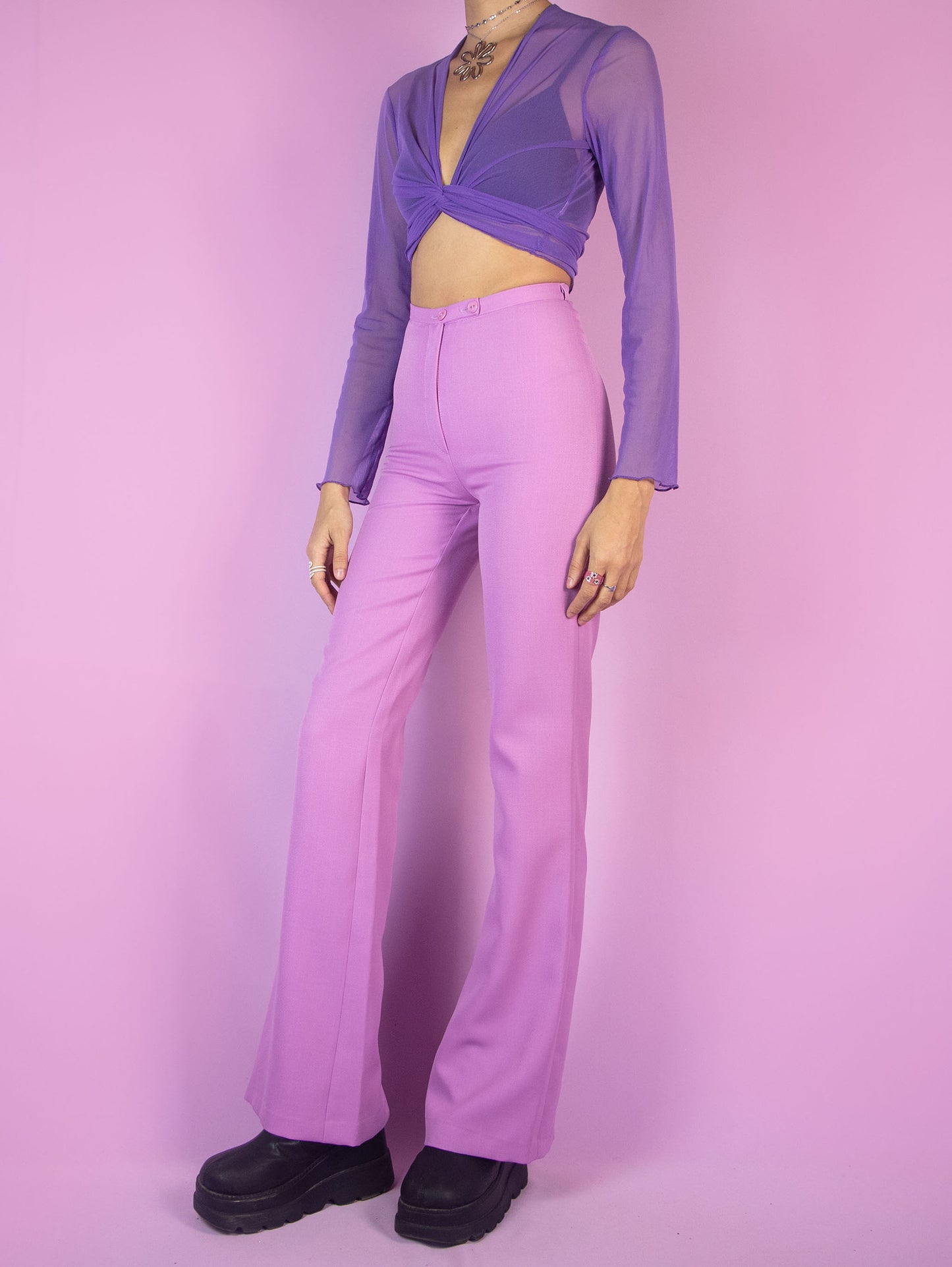 The Vintage 90s Pink Tailored Wide Pants are light pastel lilac high-waisted pants with a zipper closure and slits at the hem. Elegant evening party 1990s classic pleated trousers.