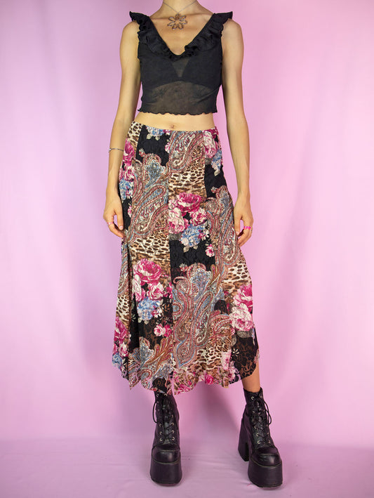 The Y2K Boho Lace Midi Skirt is a vintage floral abstract paisley animal print pattern mesh skirt with a spliced hem and an elasticated waist. Avant garde fairy grunge 2000s summer maxi skirt.