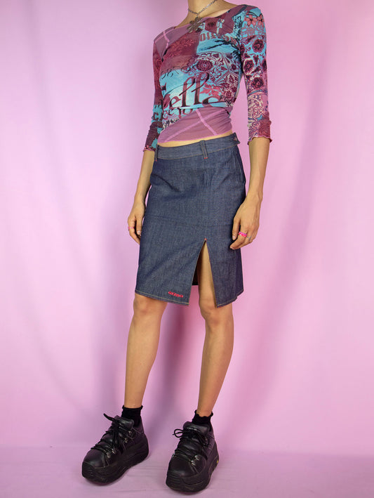 The Y2K Low Rise Denim Skirt is a vintage dark denim mini skirt featuring a front slit and side zipper closure. Cyber grunge 2000s subversive asymmetric jean skirt.