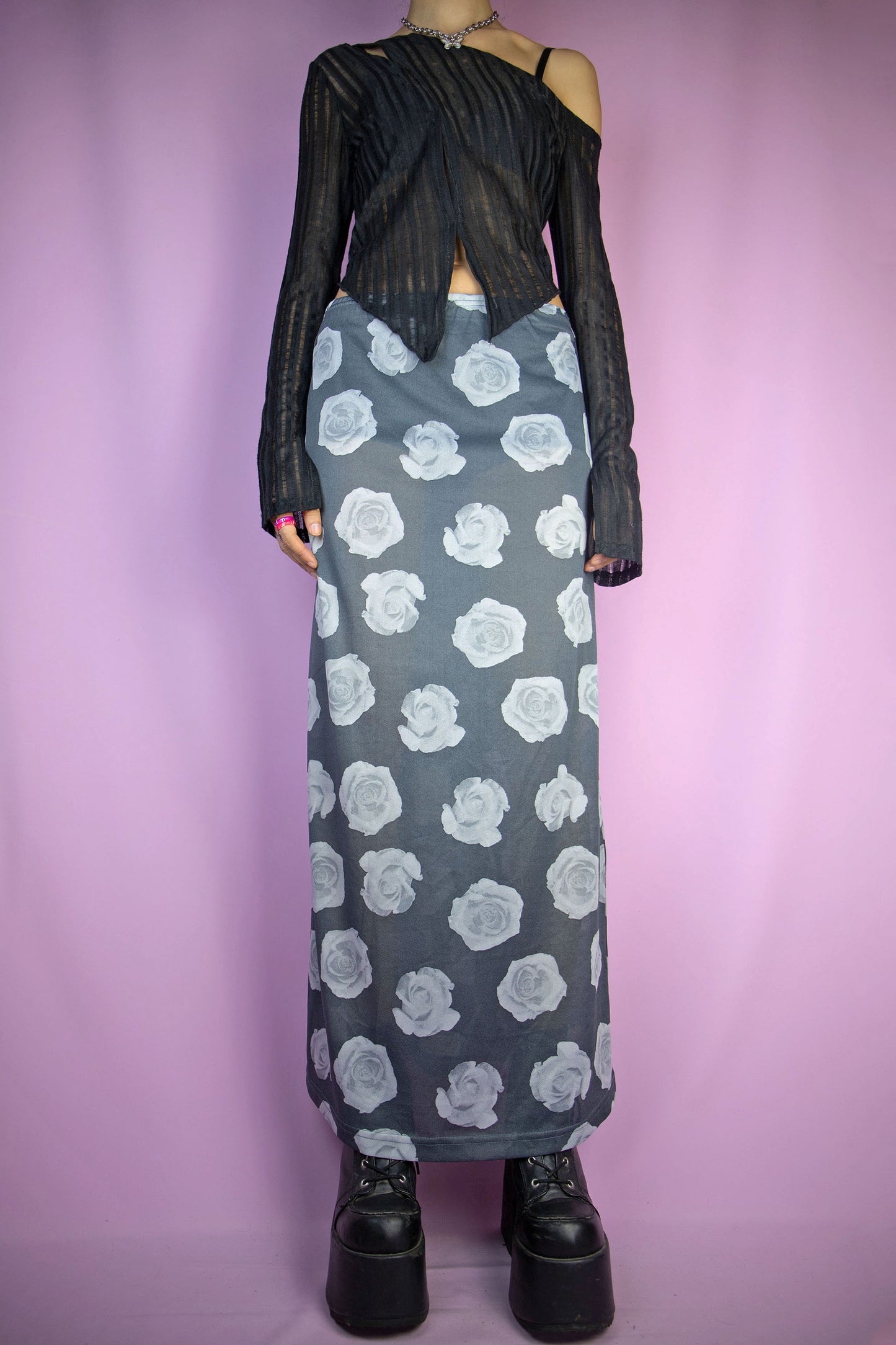 The Vintage 90s Print Sheer Midi Skirt is a semi-sheer gray rose floral graphic skirt with an elasticated waist. Boho grunge 1990s summer festival maxi skirt.