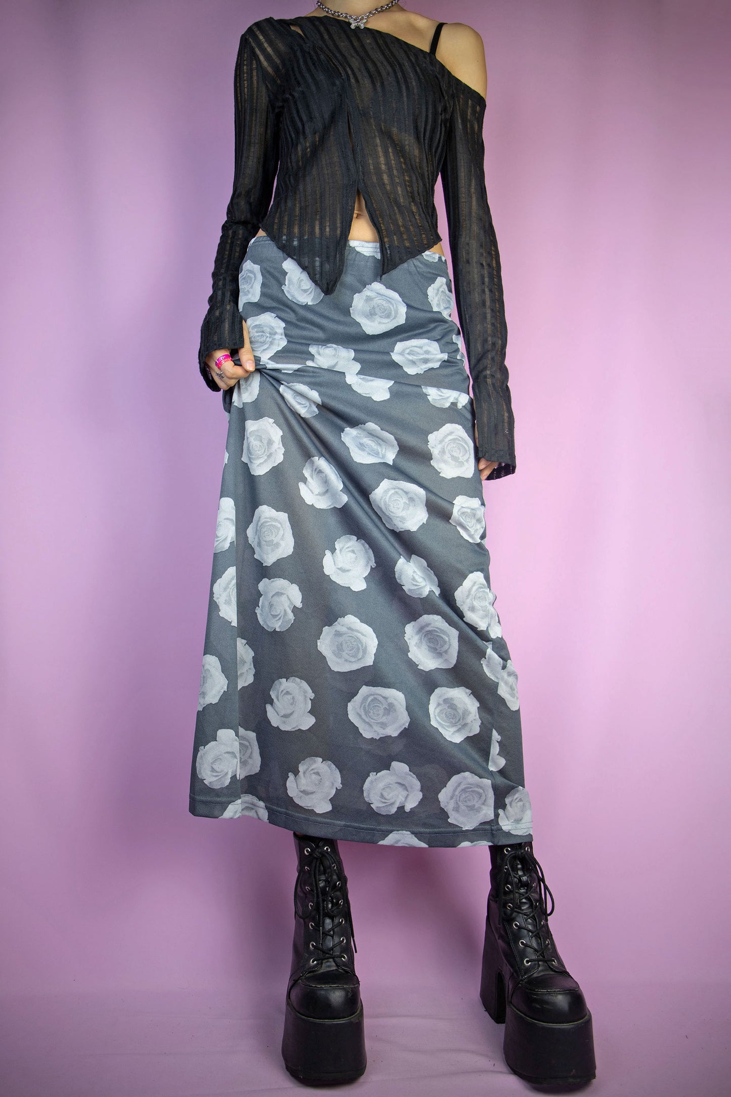 The Vintage 90s Print Sheer Midi Skirt is a semi-sheer gray rose floral graphic skirt with an elasticated waist. Boho grunge 1990s summer festival maxi skirt.