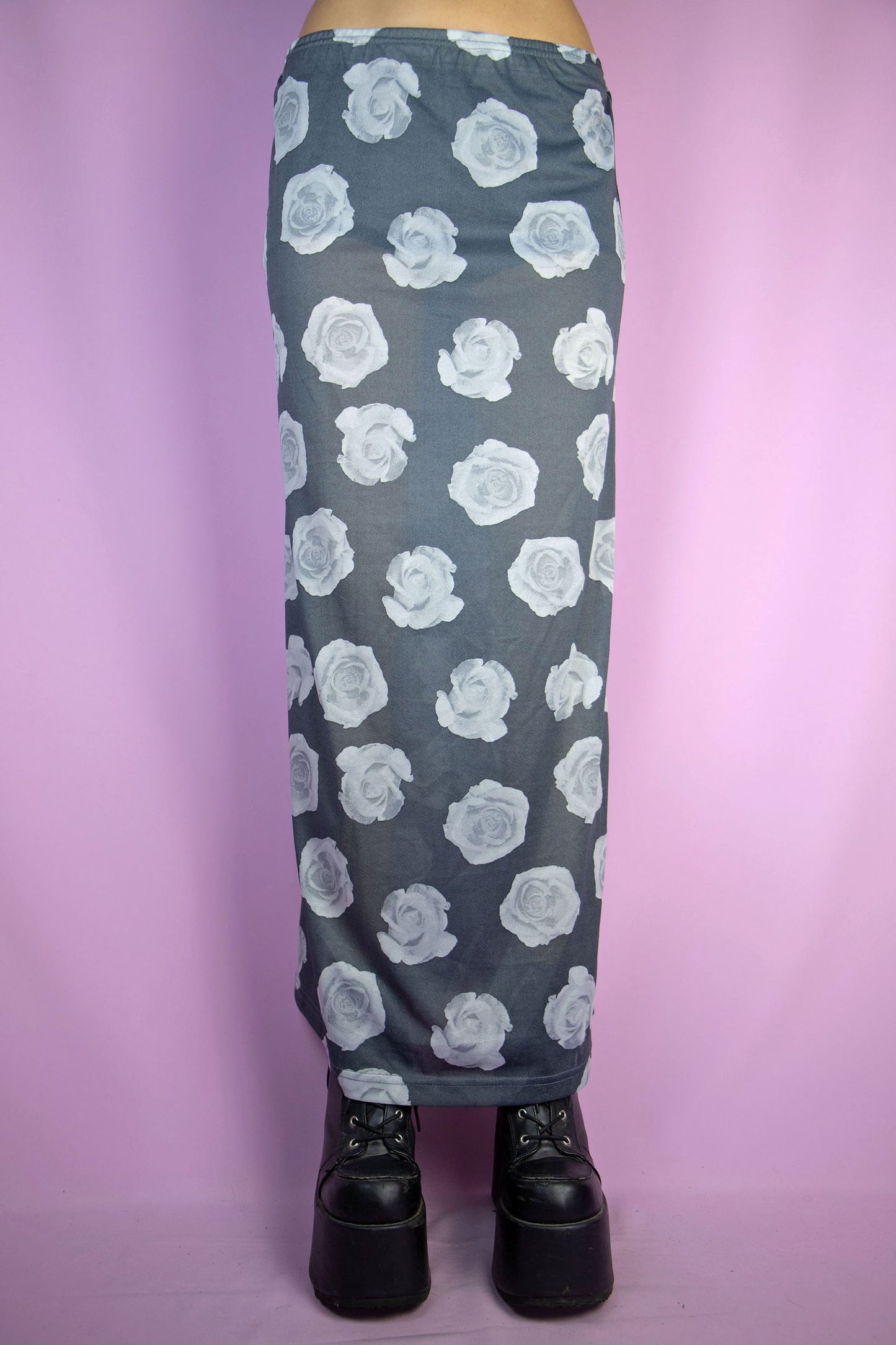 The Vintage 90s Print Sheer Midi Skirt is a semi-sheer gray rose floral graphic skirt with an elasticated waist. Boho grunge 1990s summer festival maxi skirt.