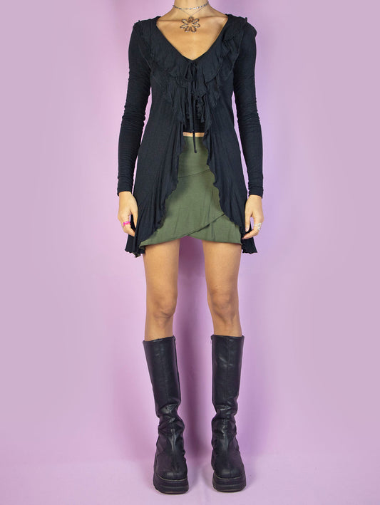 The Y2K Black Ruffle Tie Top is a vintage 2000s fairy goth inspired long-sleeve duster jacket with ruffles and tied at the front.