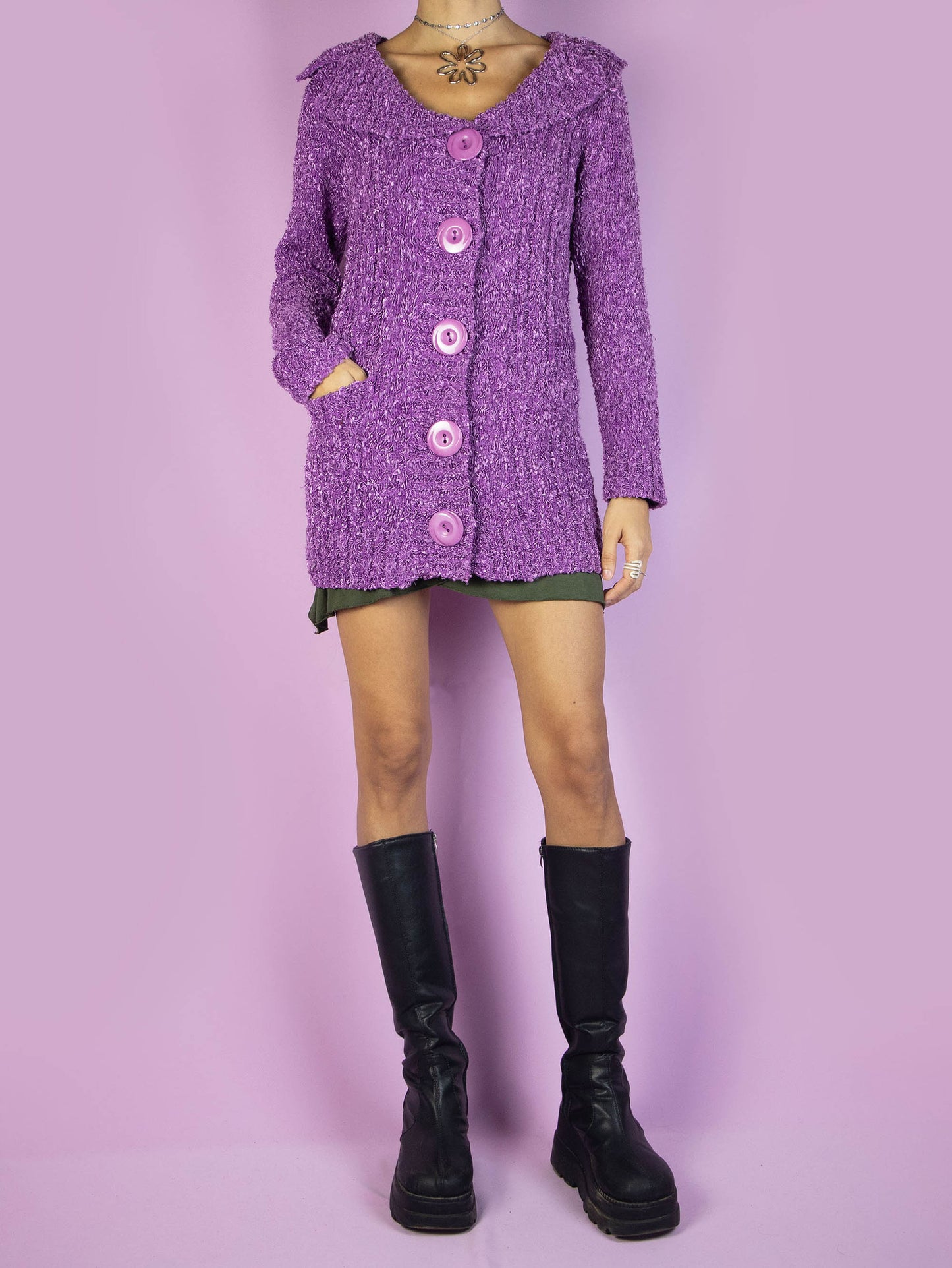 The Y2K Purple Knit Cardigan is a vintage 2000s winter chunky knit cardigan sweater with a collar, pockets, and big buttons.