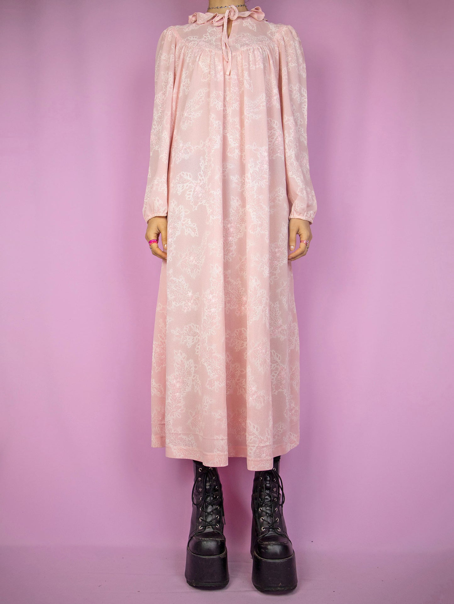 The Vintage 90s Pink Floral Nightgown Dress is a romantic cottagecore-inspired pastel pink puff sleeve midi night dress lounge sleepwear with a tied-up front ruffled neckline.