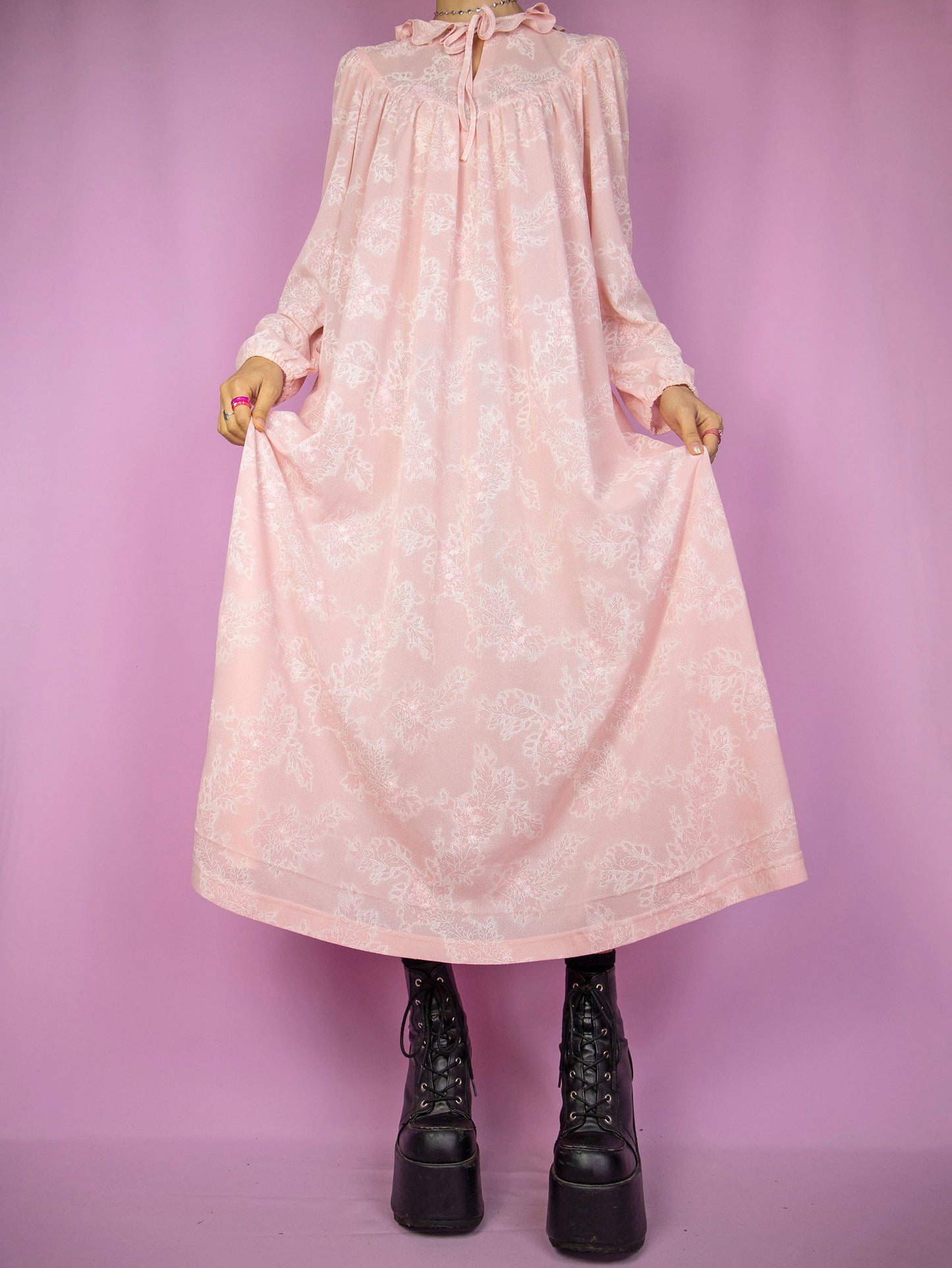 The Vintage 90s Pink Floral Nightgown Dress is a romantic cottagecore-inspired pastel pink puff sleeve midi night dress lounge sleepwear with a tied-up front ruffled neckline.