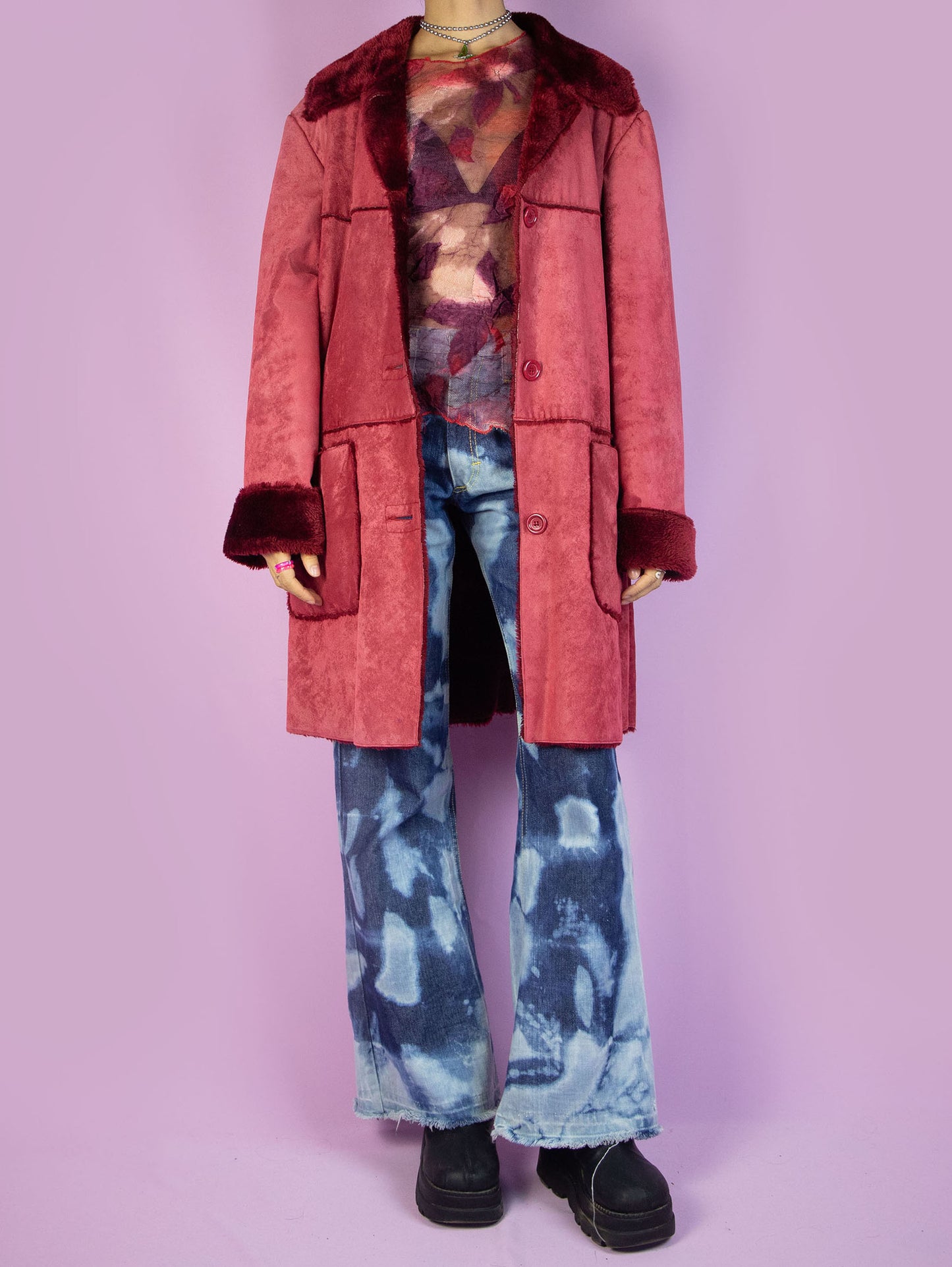 The Y2K Red Faux Fur Coat is a vintage red faux suede coat with faux fur interior, collar, and cuffs, featuring pockets and a button closure. Stunning boho grunge whimsygoth winter statement jacket from the 2000s.
