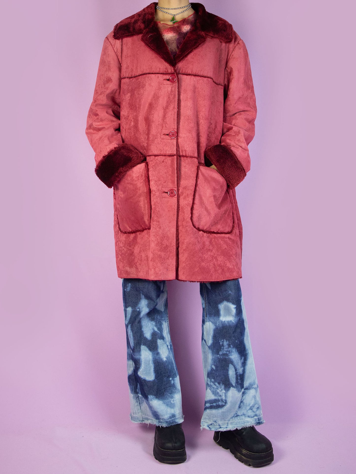 The Y2K Red Faux Fur Coat is a vintage red faux suede coat with faux fur interior, collar, and cuffs, featuring pockets and a button closure. Stunning boho grunge whimsygoth winter statement jacket from the 2000s.