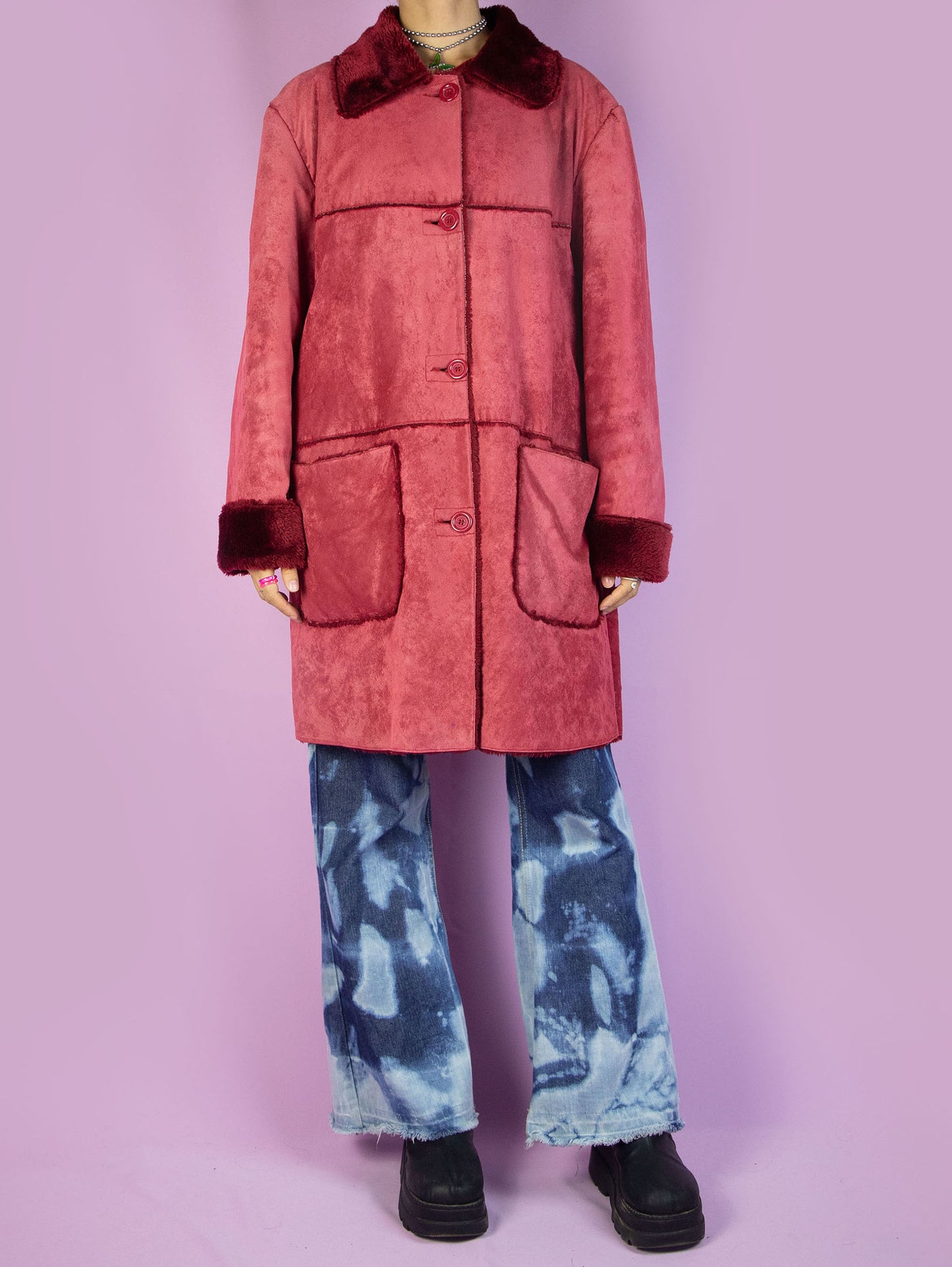 The Y2K Red Faux Fur Coat is a vintage red faux suede coat with faux fur interior, collar, and cuffs, featuring pockets and a button closure. Stunning boho grunge whimsygoth winter statement jacket from the 2000s.