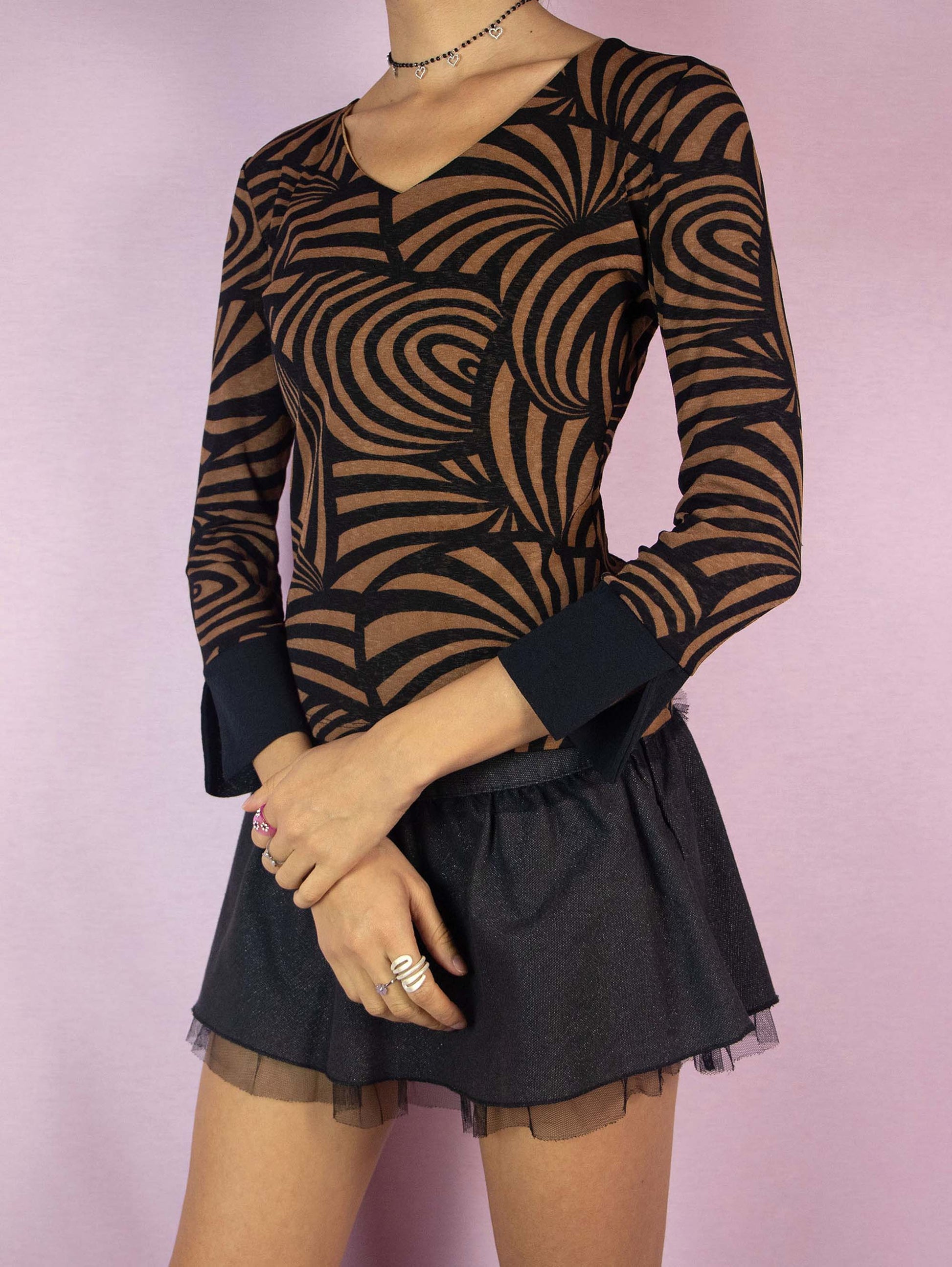 The Y2K Abstract Printed Mesh Top is a vintage 2000s brown and black three-quarter sleeve shirt with a swirl stripe graphic and V-neckline.