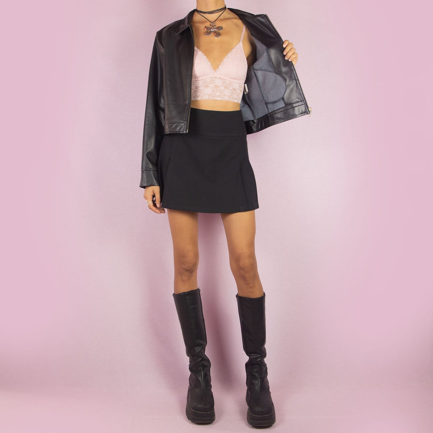 The Y2K Black Faux Leather Jacket is a vintage 2000s sleek and minimalist piece featuring a zip-up front, classic collar, shoulder pads, cropped cut, and a smooth faux leather finish. Ideal for casual fall looks or a night out.