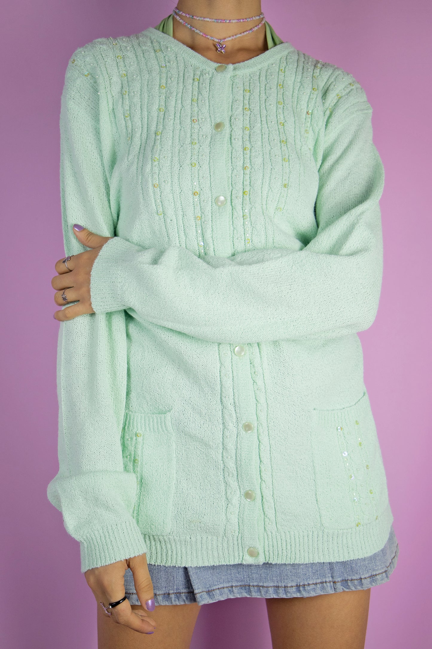 The Y2K Green Beaded Knit Cardigan is a vintage 2000s romantic pastel light mint green embellished sweater with pockets and bead and sequin detail.
