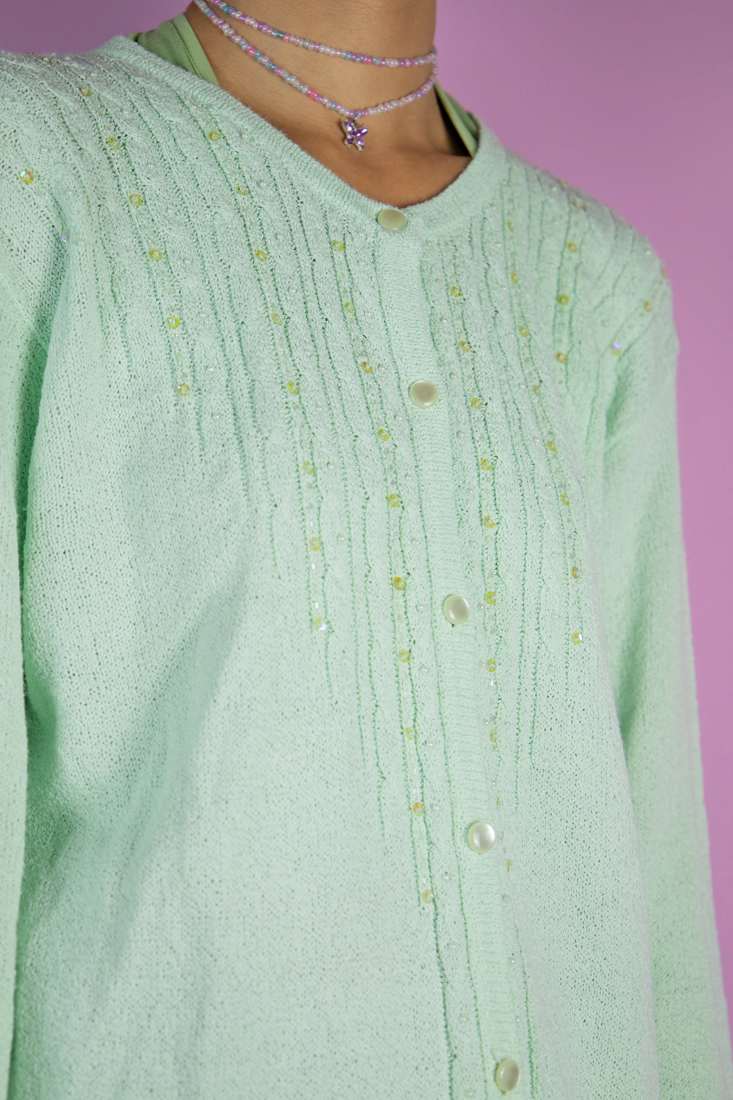 The Y2K Green Beaded Knit Cardigan is a vintage 2000s romantic pastel light mint green embellished sweater with pockets and bead and sequin detail.