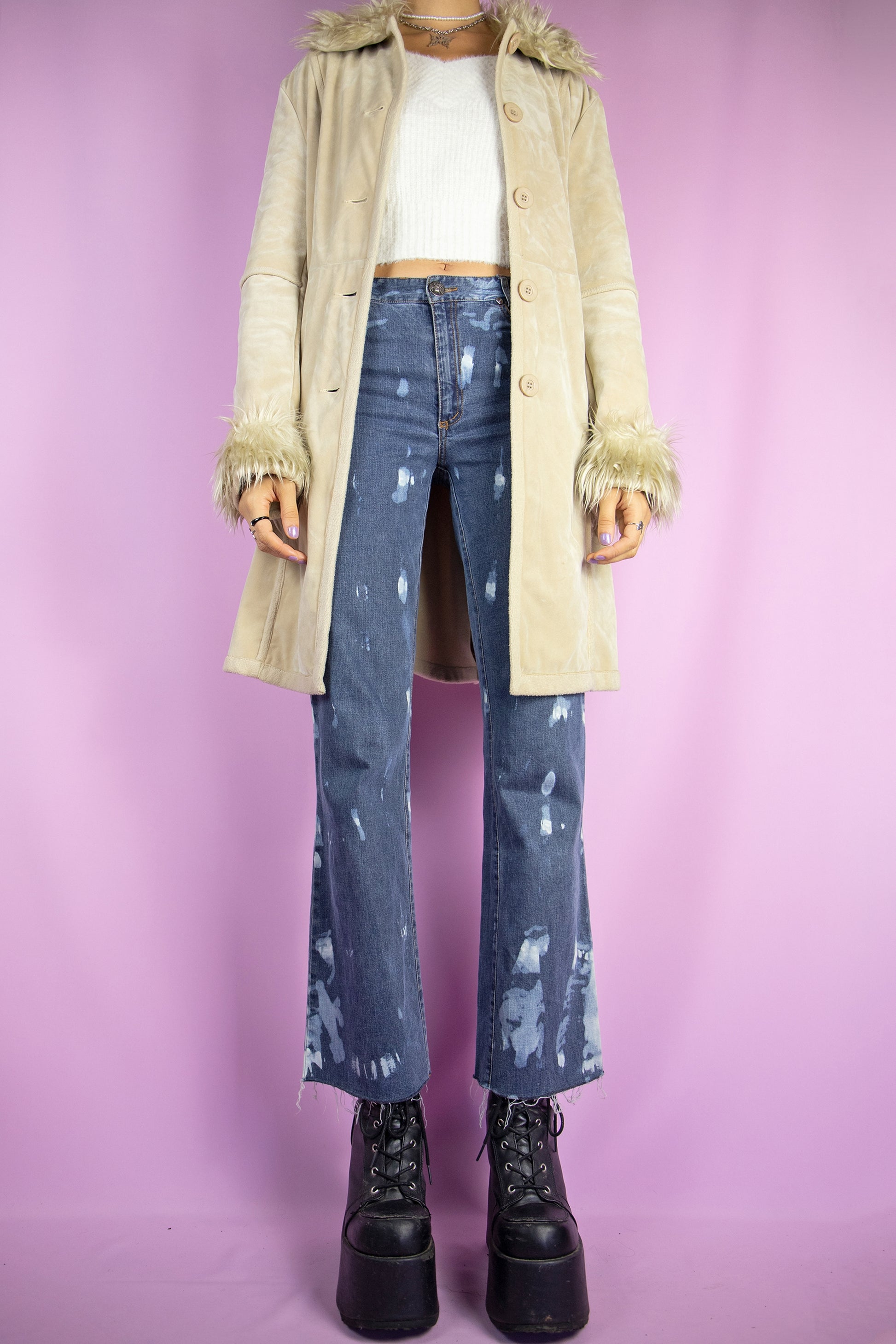 The Y2K Beige Penny Lane Jacket is a vintage 2000s winter faux suede statement coat showcasing faux fur collar and cuffs, along with pockets, buttons, and a coordinating belt.