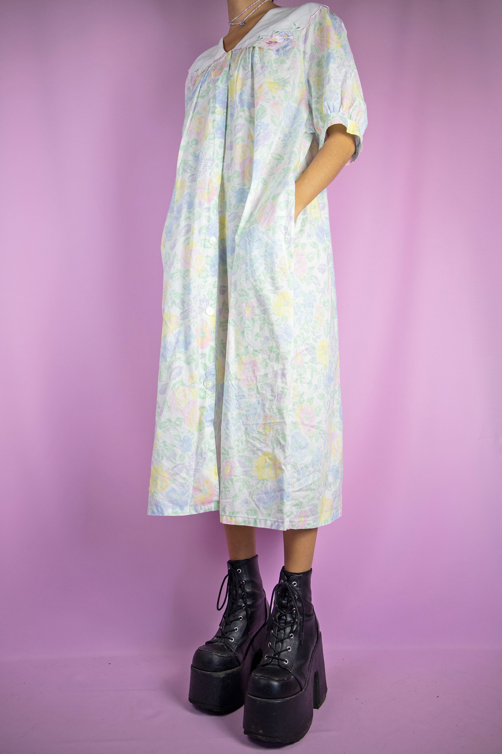 The Vintage 90s Floral Nightgown Dress is a romantic cottagecore-inspired white multicolored printed collared midi night dress lounge sleepwear with short puff sleeves, buttons and pockets.