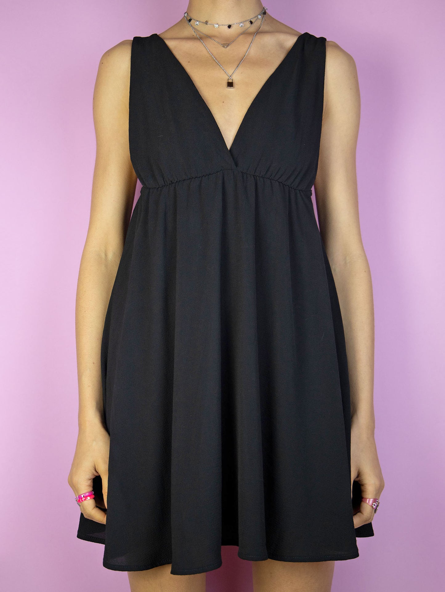 The Y2K Black Party Mini Dress is a vintage 2000s party night out style sleeveless fit and flare dress with a deep v-neck.