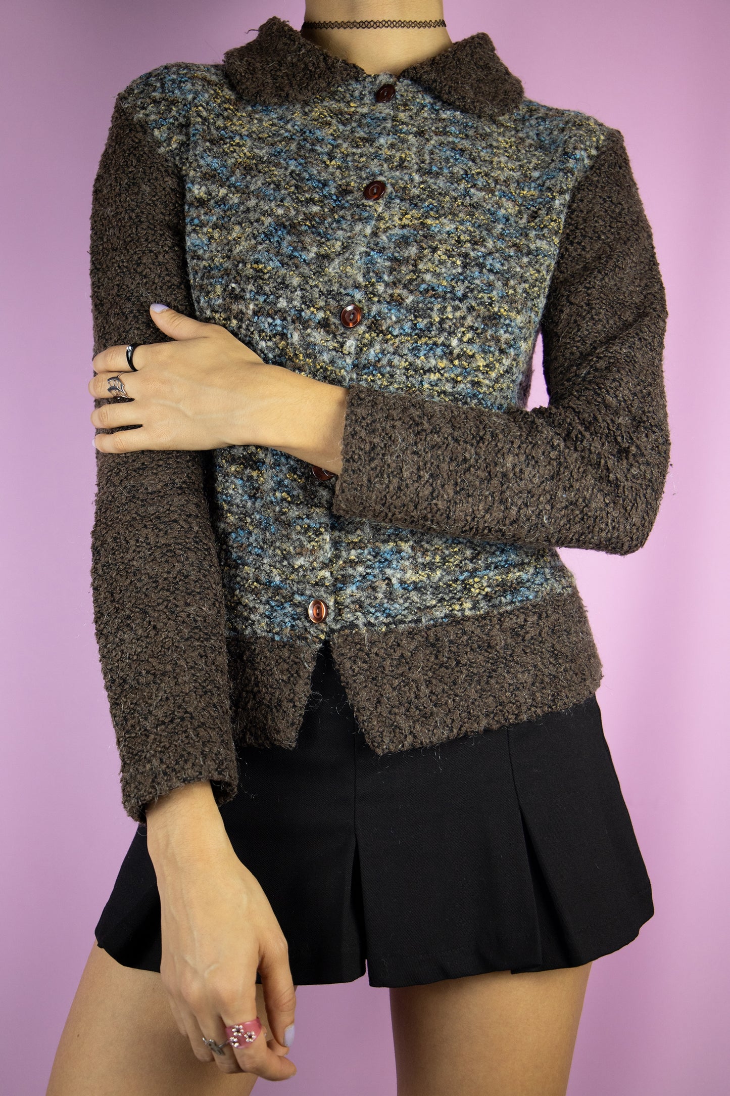 The Vintage 90s Fairy Grunge Brown Cardigan is a dark brown, beige and blue wool blend knit sweater with a collar and buttons.
