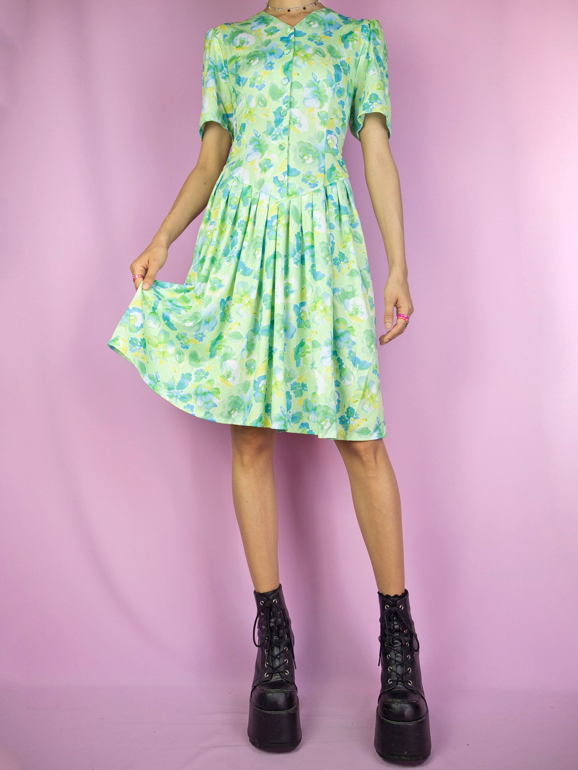 The Vintage 90s Retro Green Floral Dress is a light green blue and yellow floral short sleeve button pleated dress. Boho grunge 1990s summer mini dress.