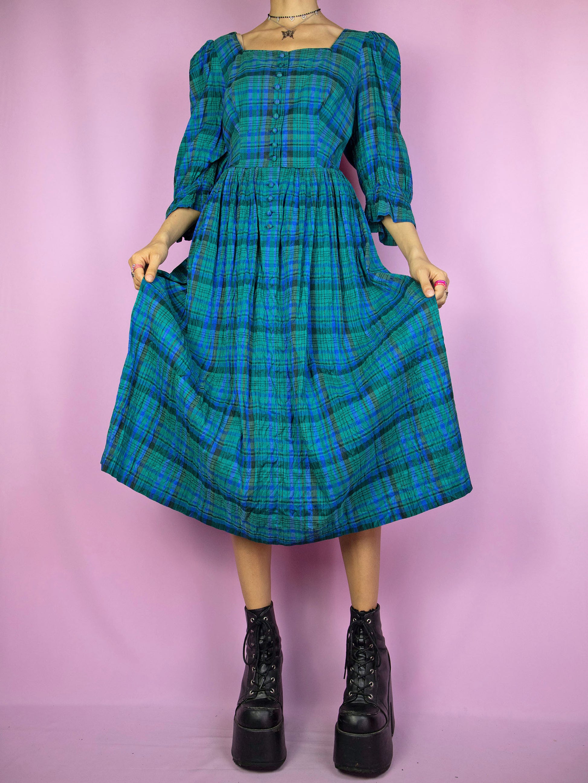 The Vintage 80s Cottage Plaid Midi Dress is a pleated blue and green check dress with puff sleeves and buttons. Boho country western 1980s prairie midi dress.