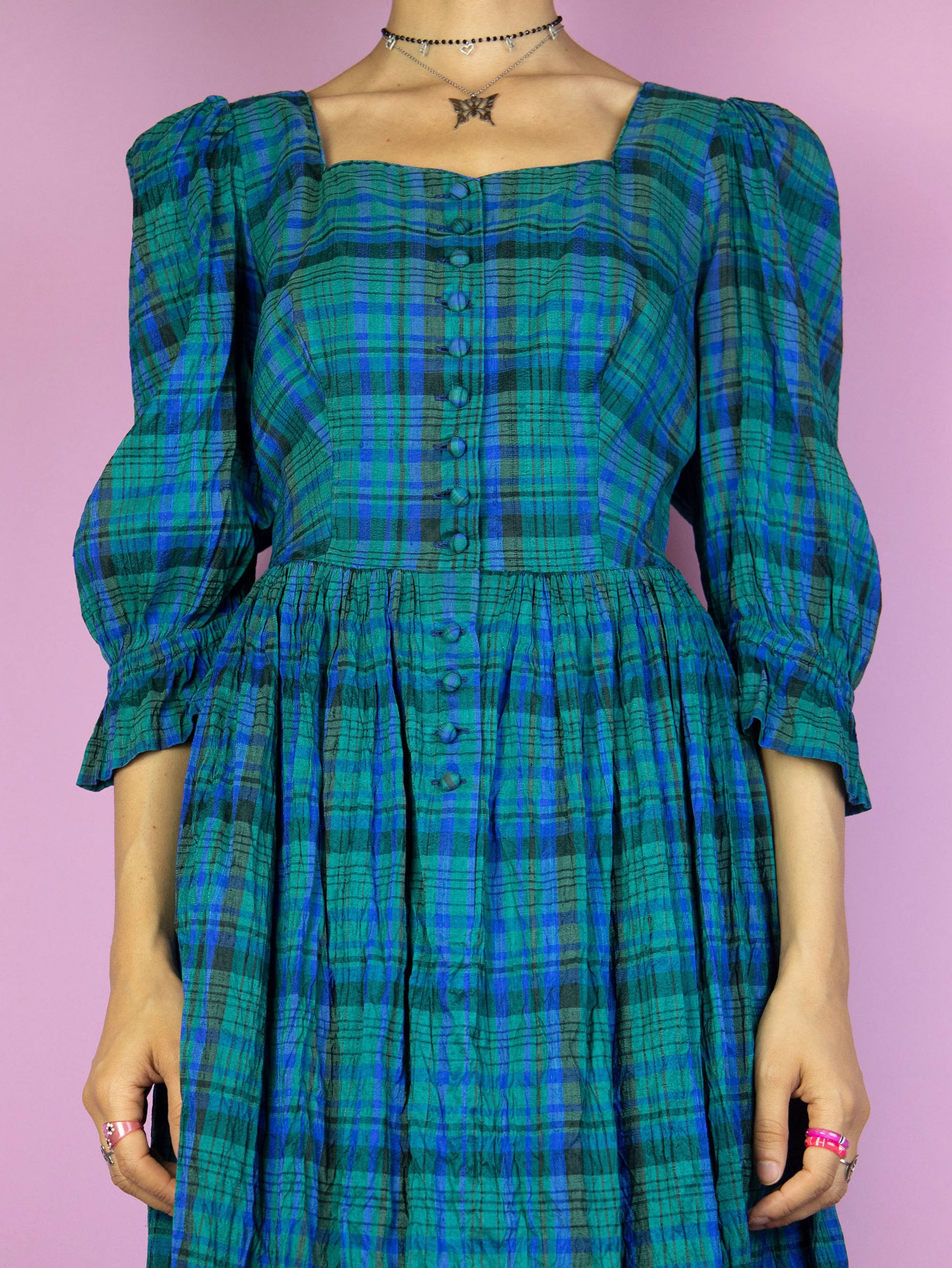 The Vintage 80s Cottage Plaid Midi Dress is a pleated blue and green check dress with puff sleeves and buttons. Boho country western 1980s prairie midi dress.