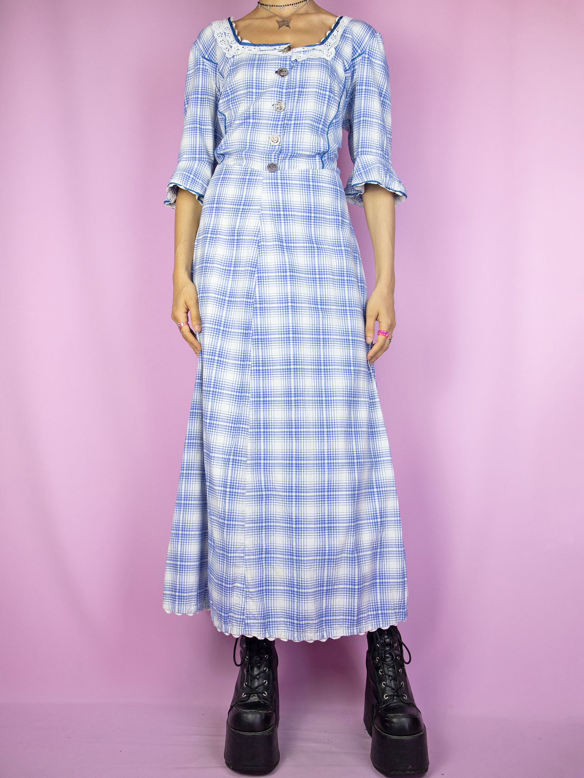 The Vintage 80s Cottage Plaid Maxi Dress is a blue and white check midi dress with buttons, short bell sleeves and a side zipper closure. Milkmaid prairie inspired 1980s country western gingham dress.