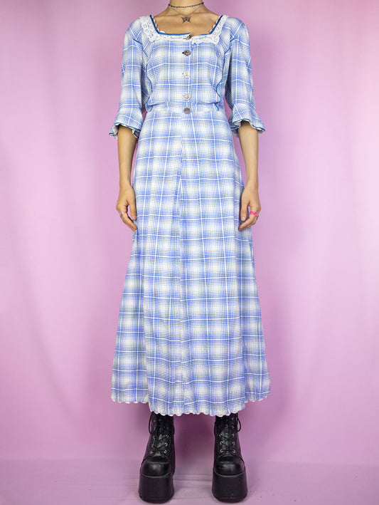 The Vintage 80s Cottage Plaid Maxi Dress is a blue and white check midi dress with buttons, short bell sleeves and a side zipper closure. Milkmaid prairie inspired 1980s country western gingham dress.