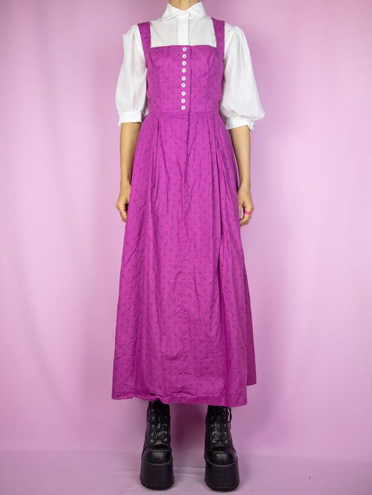 The Vintage 90s Purple Prairie Maxi Dress is a sleeveless floral dress with pleats and buttons. Boho country western cottage inspired 1990s midi dress. The white blouse shown underneath is not included.