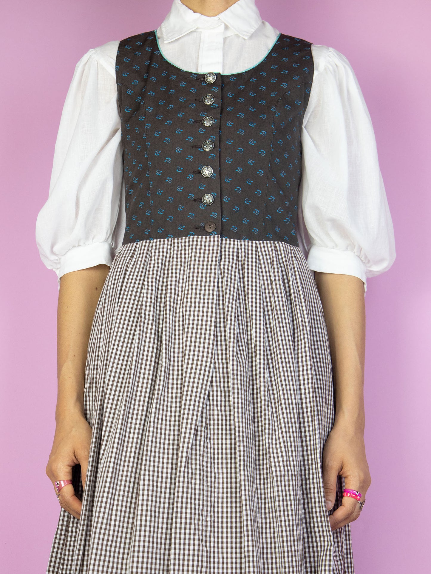 The Vintage 90s Brown Plaid Midi Dress is a sleeveless floral check dress with buttons. Cottage prairie 1990s gingham dress. The white blouse shown underneath is not included.