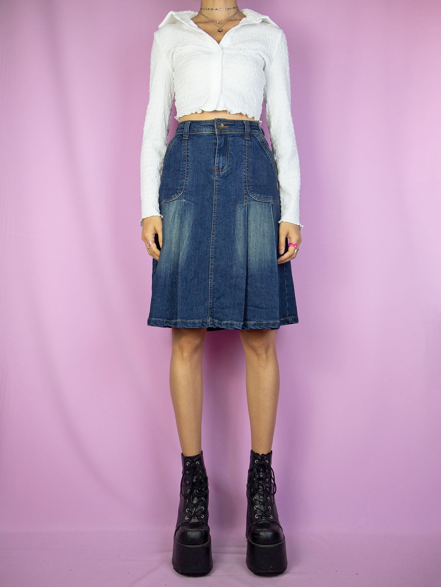 The Y2K Denim Pleated Skirt is a vintage acid wash pleated denim skirt with pockets and embroidered floral detail on the back. Cyber grunge 2000s jean mini skirt.